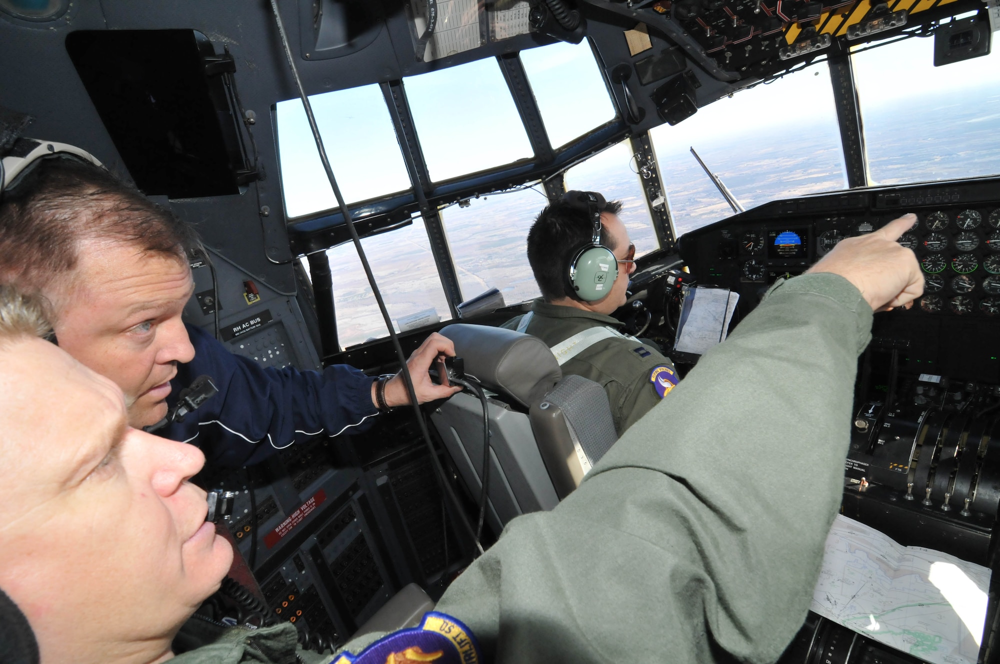 Senior Master Sgt. Bill Rogers points out landmarks from the C-130 cockpit during the Educators Flight April 13. (Air Force Photo/Paul Zadach)