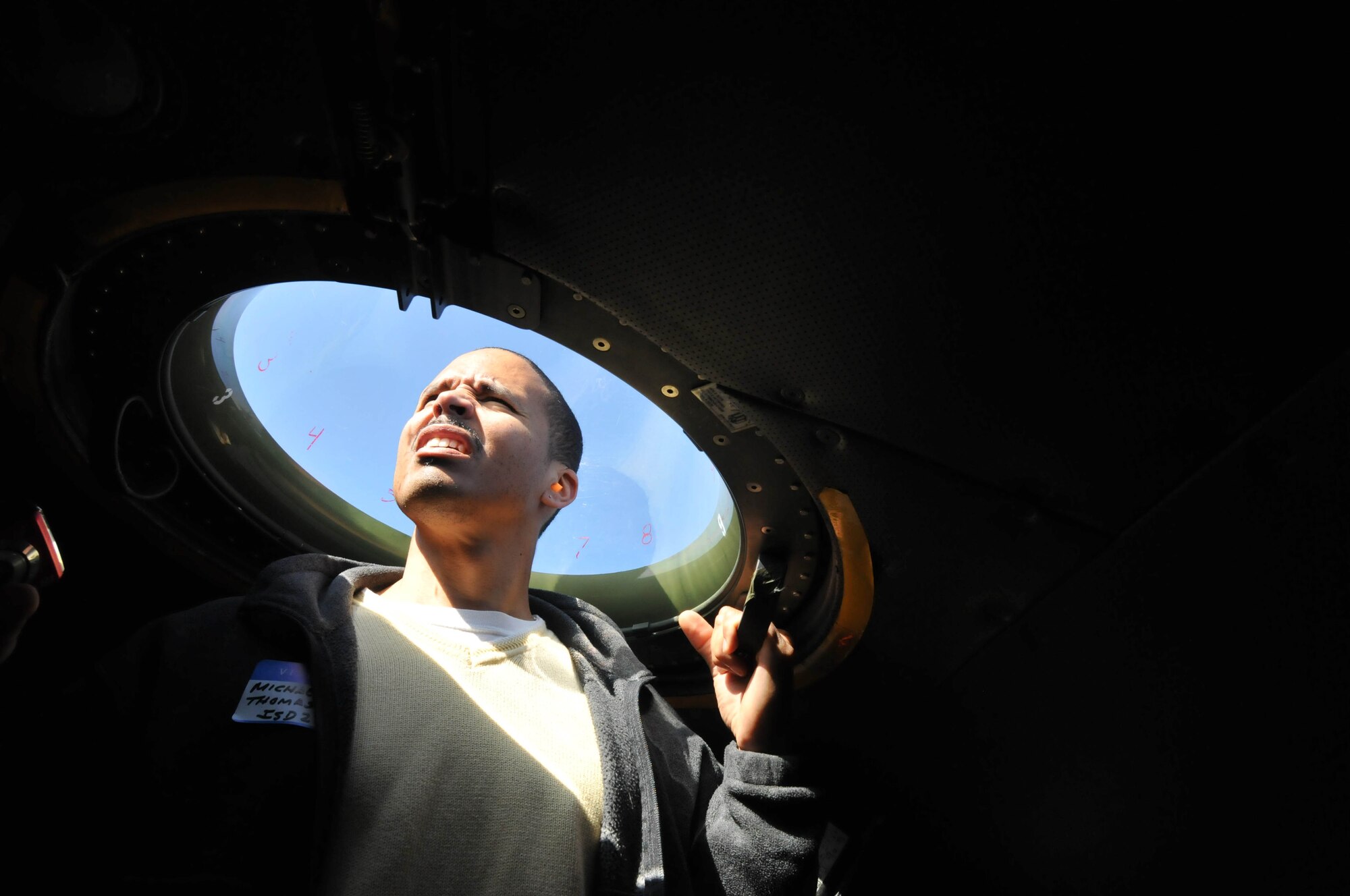 Michael Thomas, Independent School District 279, gets a panoramic view from the C-130 cockpit bubble during the Educators Flight April 13. (Air Force Photo/Paul Zadach)
