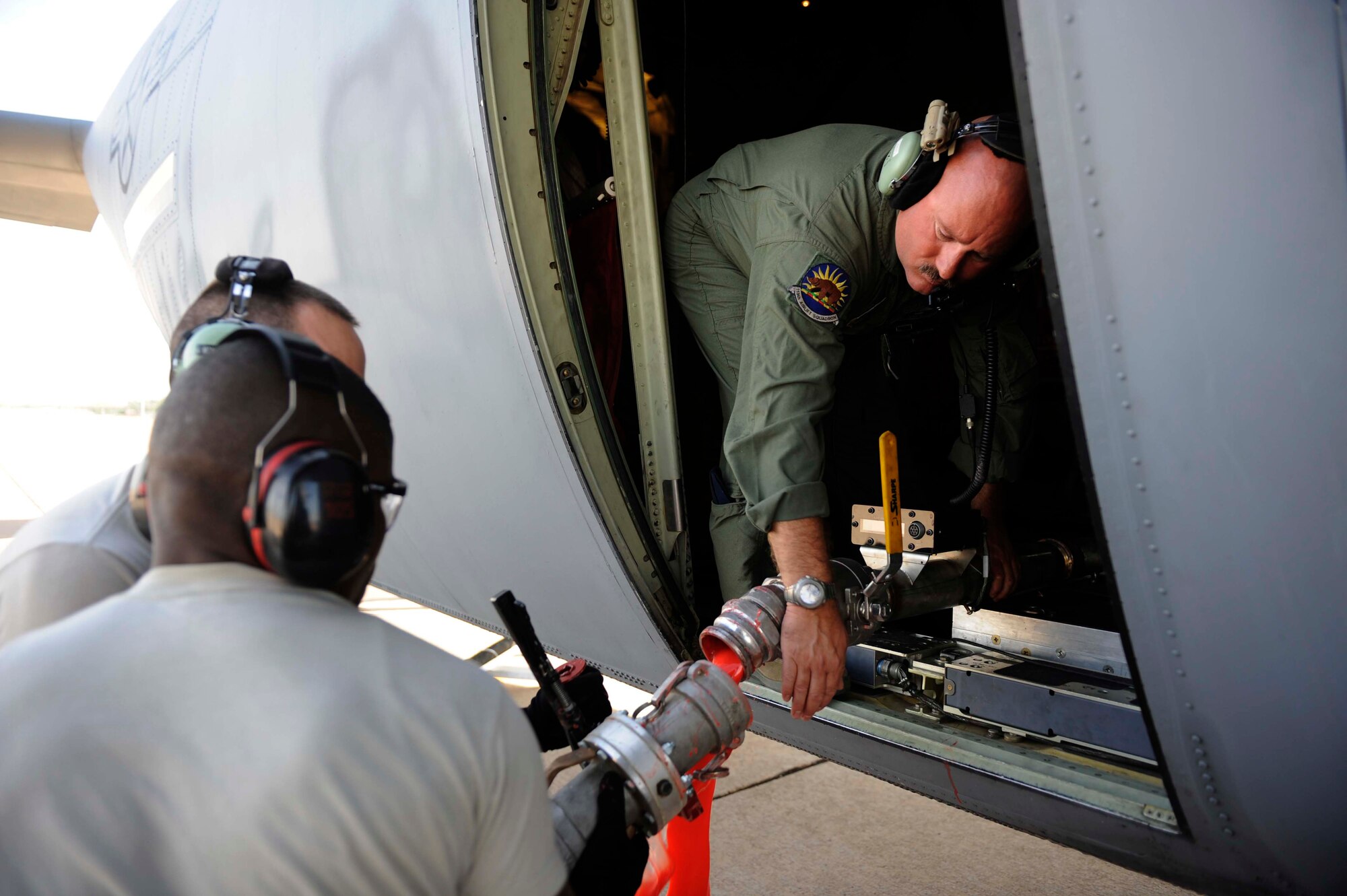 Airmen from California Air National Guard's 146th Airlift Wing, North Carolina Air National Guard's 145th Airlift Wing and Wyoming Air National Guard's 153rd Airlift Wing remove a fire retardant hose from a C-130H Hercules equipped with the Modular Airborne Firefighting System at Dyess Air Force Base, Texas, April 19, 2011. MAFFS is capable of dispensing 3,000 gallons of water or fire retardant in less than five seconds. Wildfires have spread across various parts of Texas and have burned more than 1,000 square miles of land.  (U.S. Air Force Photo by Staff Sgt. Eric Harris)