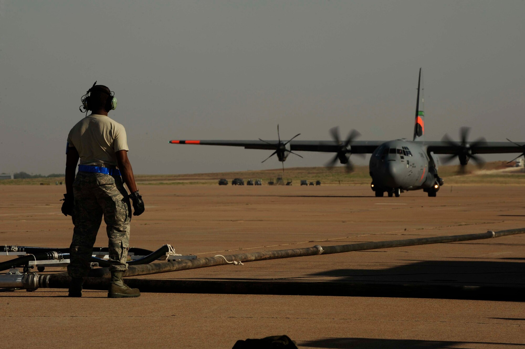 Staff Sgt. Anthony Hayes, 145th Aircraft Maintenance Squadron, North Carolina Air National Guard, prepares to refill a C-130J Hercules, equipped with the Modular Airborne Firefighting System, with fire retardant as it taxis into the pits at Dyess Air Force Base, Texas, April 19, 2011. MAFFS is capable of dispensing 3,000 gallons of water or fire retardant in less than five seconds. Wildfires have spread across various parts of Texas and have burned more than 1,000 square miles of land.  (U.S. Air Force Photo by Staff Sgt. Eric Harris)
