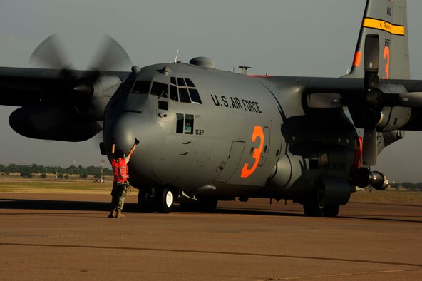Master Sgt. Jeff Tschacher, 153rd Aircraft Maintenance Squadron, Wyoming Air National Guard, directs a C-130H Hercules equipped with the Modular Airborne Firefighting System(MAFFS) to start engine two in preparation to fight wildfires burning in Texas, Dyess Air Force Base, Texas, April 19, 2011. MAFFS is capable of dispensing 3,000 gallons of water or fire retardant in less than five seconds. The wildfires have spread across various parts of Texas and have burned more than 1,000 square miles of land.  (U.S. Air Force Photo by Staff Sgt. Eric Harris)