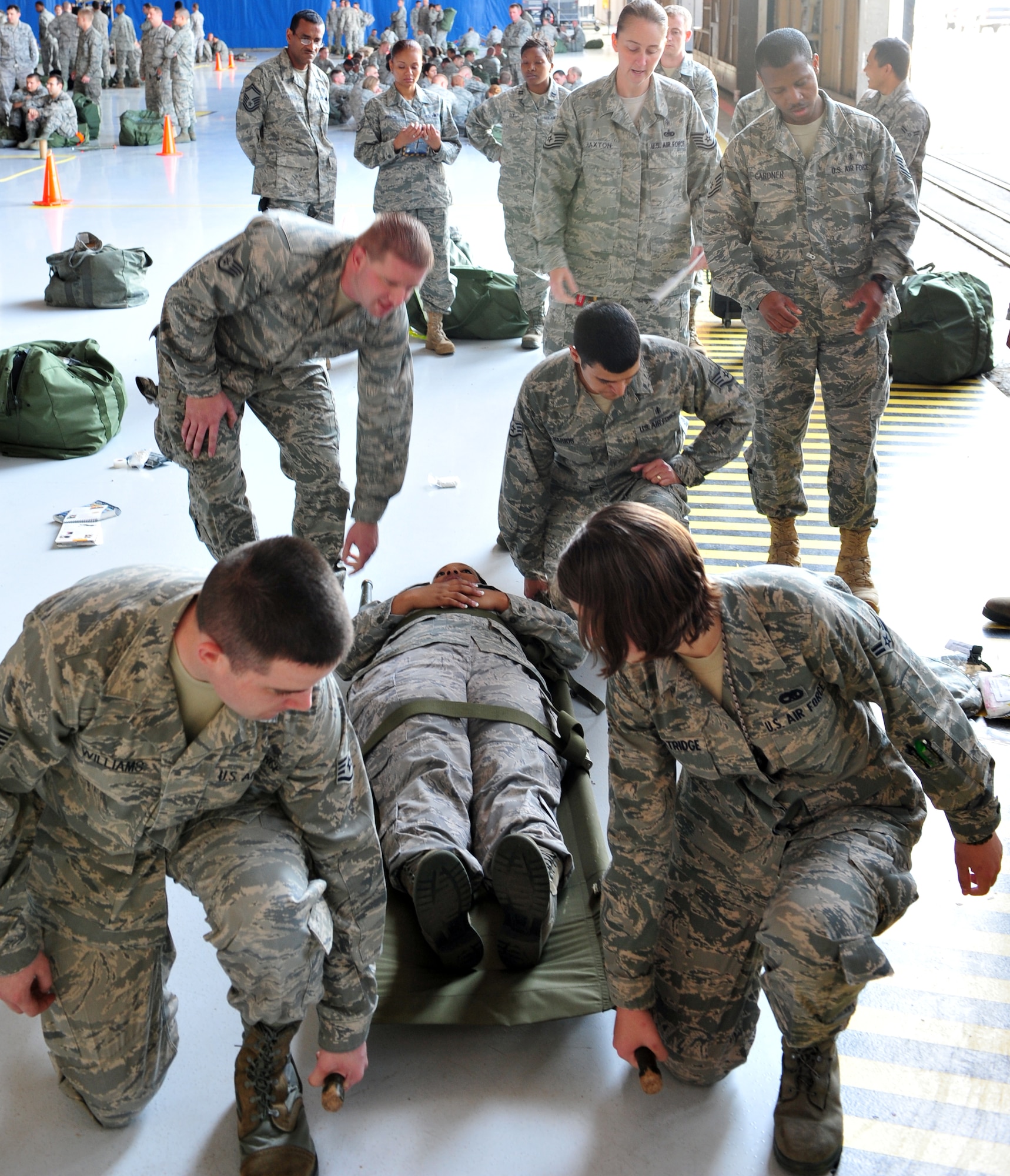 SHAW AIR FORCE BASE, S.C. - Shaw Airmen participate in the Ability to Survive and Operate Rodeo in hanger 1200 April 19, 2011. The rodeo gave Airmen the opportunity to practice hands-on war time scenarios for self-aid and buddy care, decontamination, reporting procedures and unexploded explosive ordinance identification.(U.S. Air Force photo/Airman 1st Class Tabatha L. Duarte (Released))
