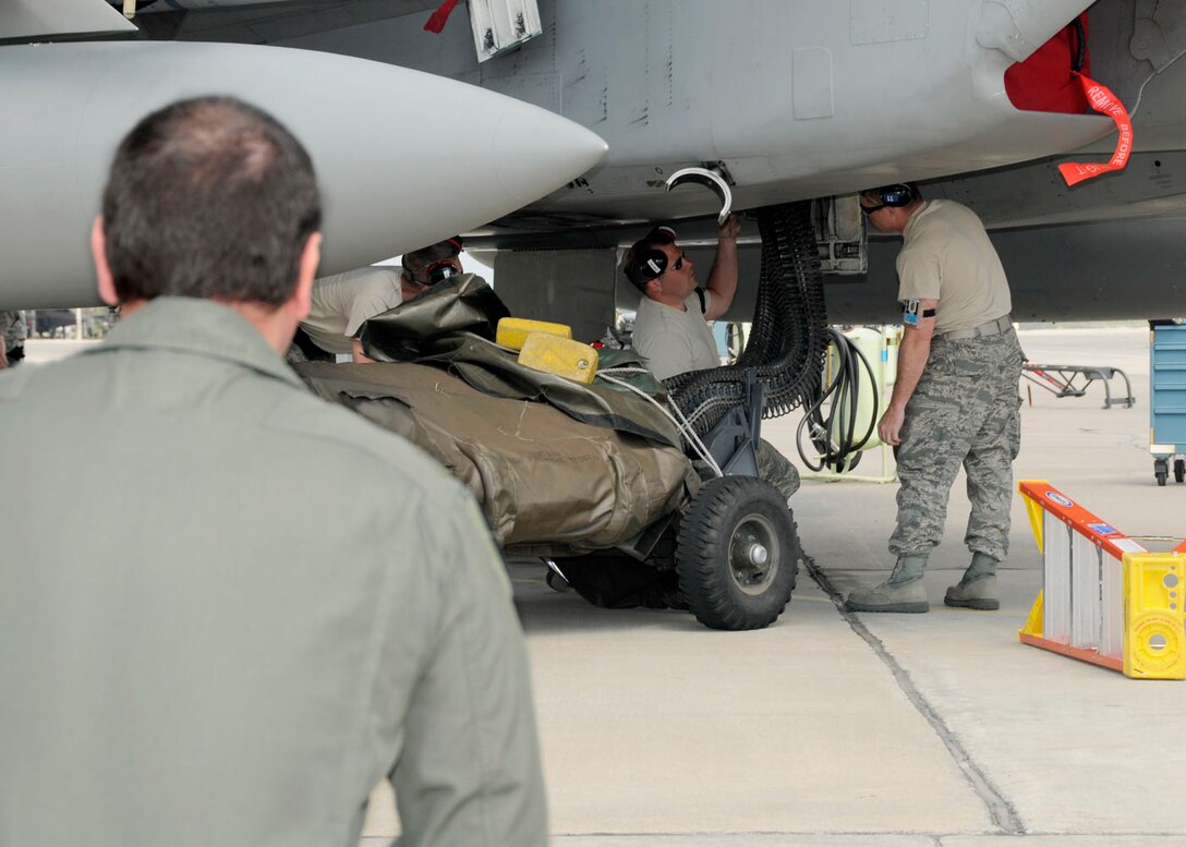 Col. Kenneth Lambrich from the 104th Fighter Wing, Massachusetts Air National Guard watches as the maintenance crew unload rounds for the first time from the F-15 at Tyndall AFB, Florida as they participate in the Weapons System Evaluation Program (WSEP), known as Combat Archer, on April 19, 2011. This training is important for the ground crews to test their maintenance systems and processes while loading live munitions on the F-15 eagle, as well as critical live war fighting training for the F-15 pilots to employ air-to-air missiles against real world targets.  (U.S.A.F. photograph by Senior Master Sgt. Robert J. Sabonis)