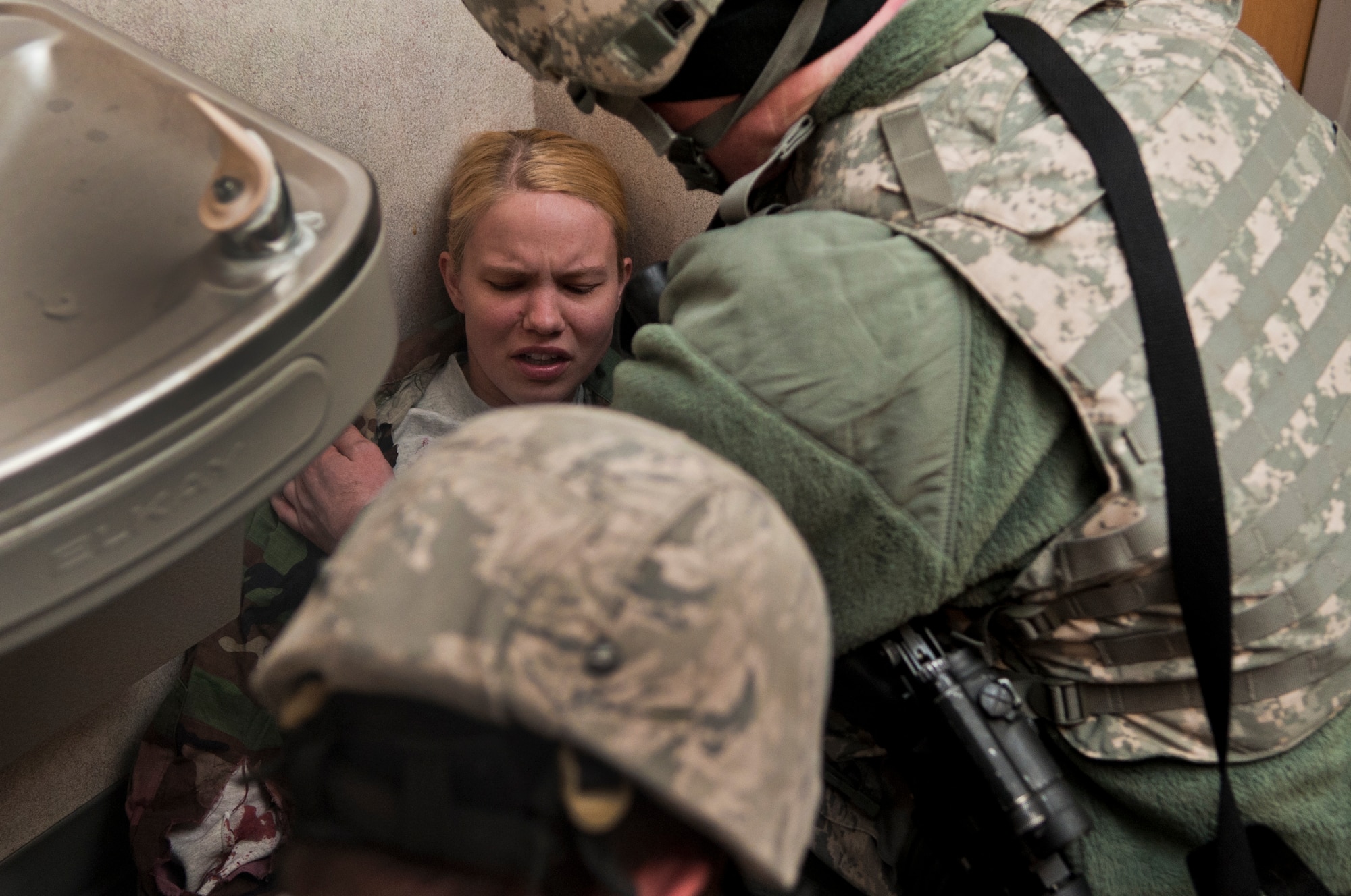 MINOT AIR FORCE BASE N.D. -- Staff Sgt. Daniel Rumfelt, 5th Security Forces Squadron security forces member, assists Capt. Michelle Olinger, 91st Missile Wing chief of inspection, during an active shooter exercise here April 19. This exercise scenario is designed to evaluate the base's implementation of force protection condition response measures as well as test the readiness and effectiveness of emergency response units. (U.S. Air Force photo/ Airman 1st Class Aaron-Forrest Wainwright)