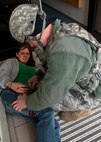 MINOT AIR FORCE BASE N.D. -- Staff Sgt. Daniel Rumfelt, 5th Security Forces Squadron security forces member, applies a tourniquet to 1st Lt. Kelly Womble, 91st Operation Support Squadron ICBM deputy instructor, during an active shooter exercise here April 19. This exercise scenario is designed to evaluate the base's implementation of force protection condition response measures as well as test the readiness and effectiveness of emergency response units. (U.S. Air Force photo/ Airman 1st Class Aaron-Forrest Wainwright)