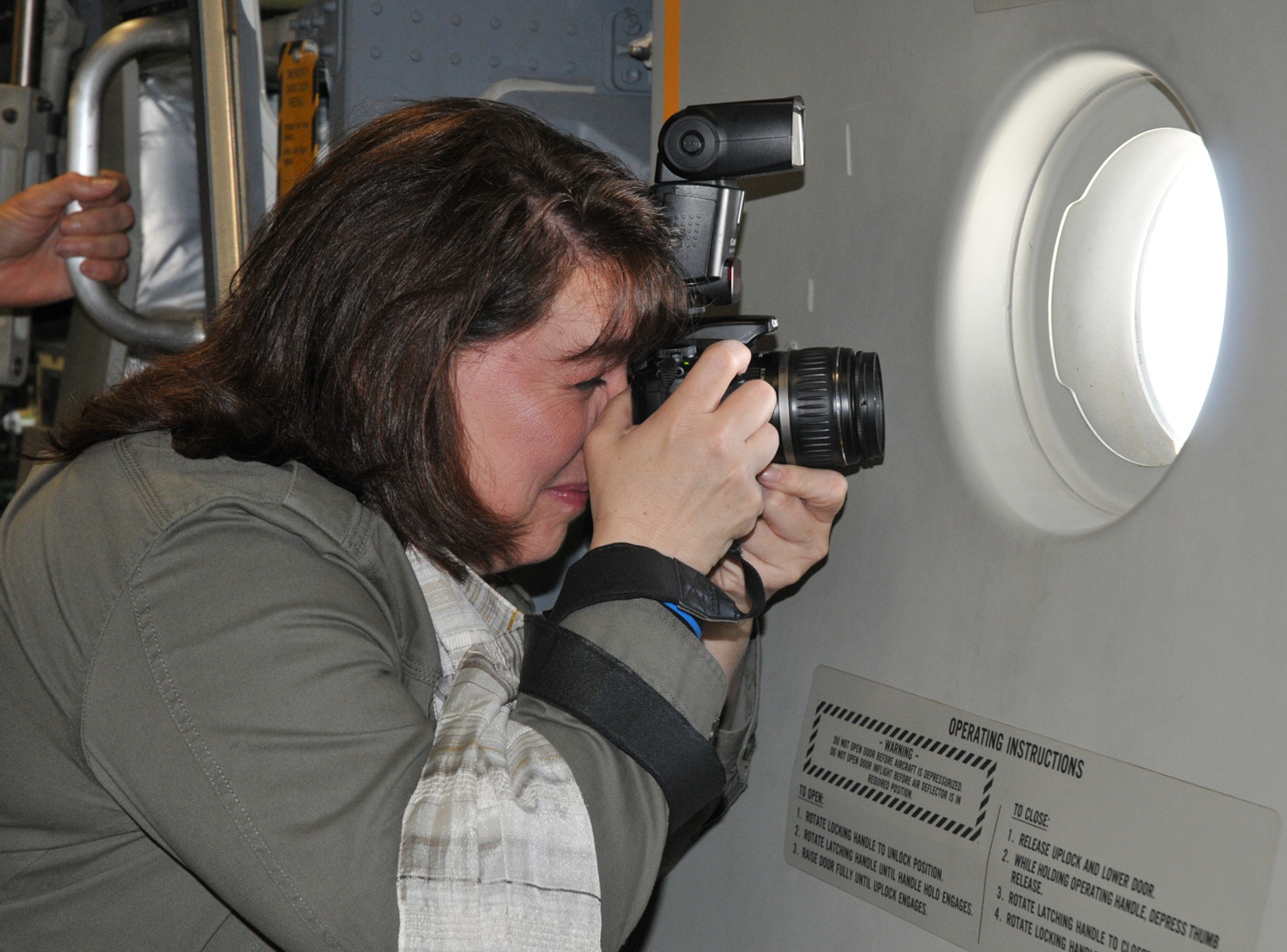 Judy Zaal, honorary commander for the 512th Security Forces Squadron and an AstraZeneca employee, takes a photo during a C-17 Globemaster III flight. Ms. Zaal is one of 25 civic leaders who attended the flight and tour of base operations April 13, 2011, at Dover Air Force Base, Del. (U.S. Air Force photo by Capt. Marnee A.C. Losurdo)