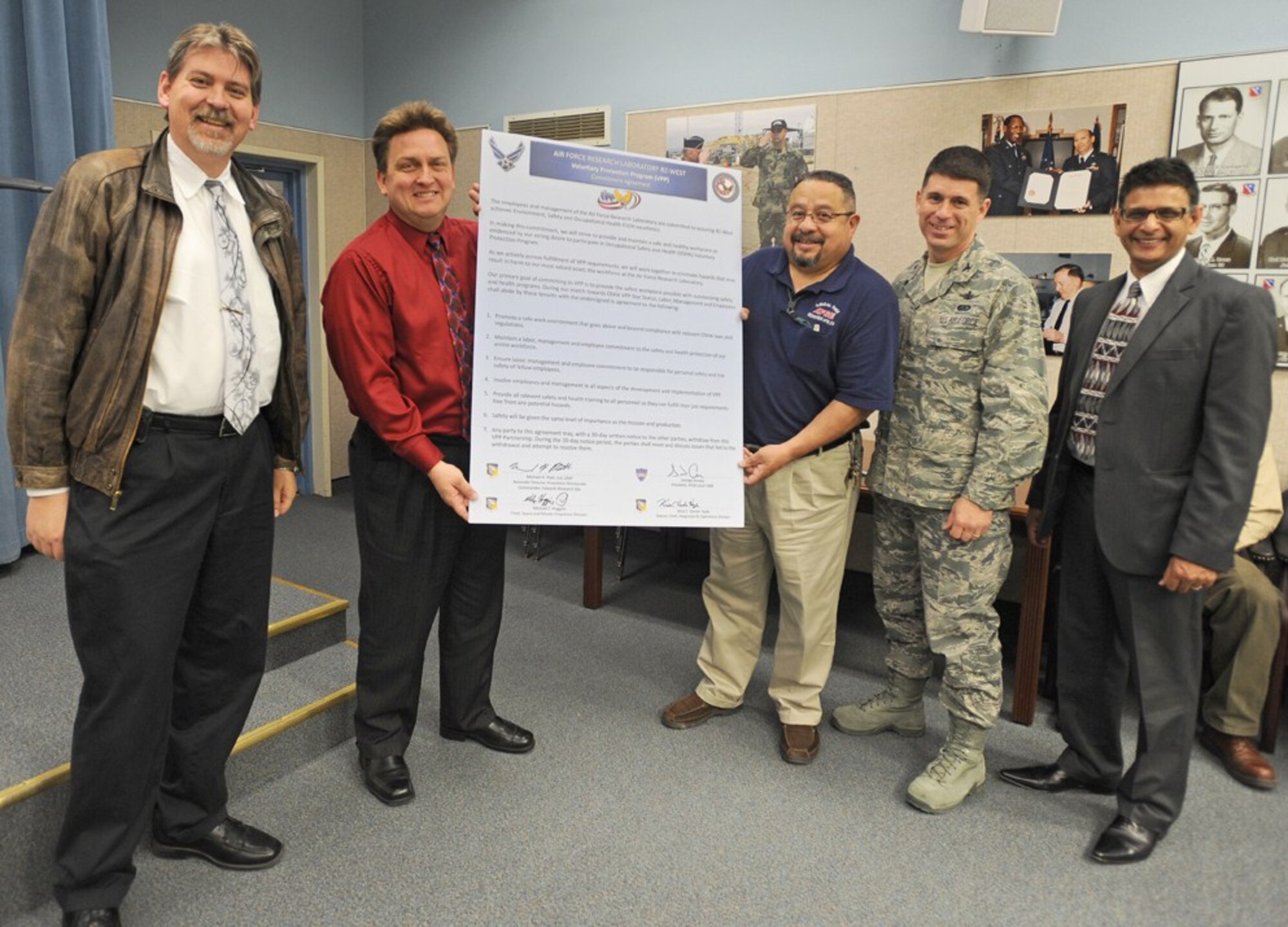 From left to right: Kriss VanderHyde, Air Force Research Laboratory Detachment 7 Integration and Operation Division deputy, Mike Huggins, AFRL Space and Missile Propulsion Division chief, George Amaya, American Federation of Government Employees base president, Col. Michael Platt AFRL Det. 7 commander, Dr. Ashwani Vij, AFRL Voluntary Protection Program manager, hold up the VPP recommitment agreement signed April 7. (Air Force photo by Ray Dyakon)