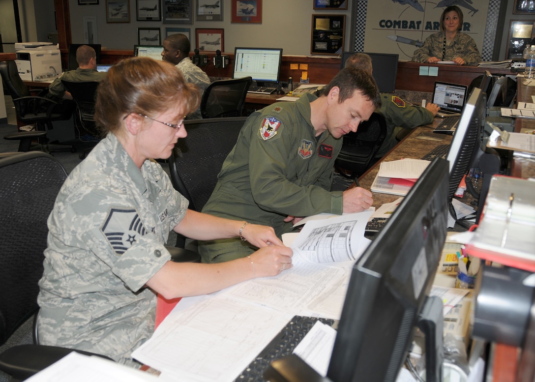 Master Sergeant Darcie Rock and a pilot from the 104th Fighter Wing work on records at the Operations Desk at Tyndall Air Force Base in Florida on April 19, 2011. While they are deployed to Tyndall Air Force Base in Florida, they are participating in the Weapons System Evaluation Program (WSEP).  (U.S. Air Force Photo by: Technical Sergeant, Melanie J. Casineau)
