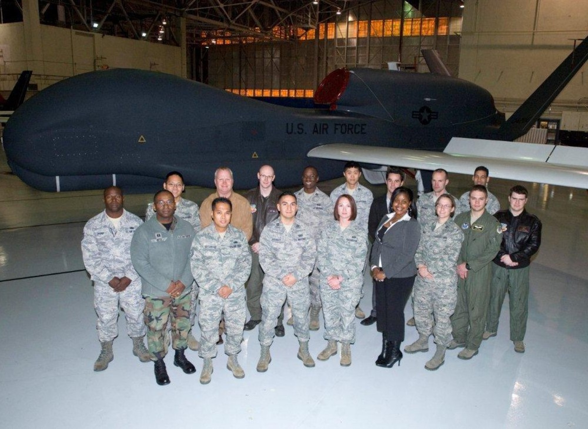 Members of the Air Force Operational Test and Evaluation Detachment 5 C2ISR Test Operations Division stand in front of a RQ-4 Global Hawk last December. The team received the Air Force Modeling and Simulation Test and Evaluation Award for their work in combining three RQ-4 Global Hawk programs into a single operational test program. (Air Force photo by Edward Cannon)