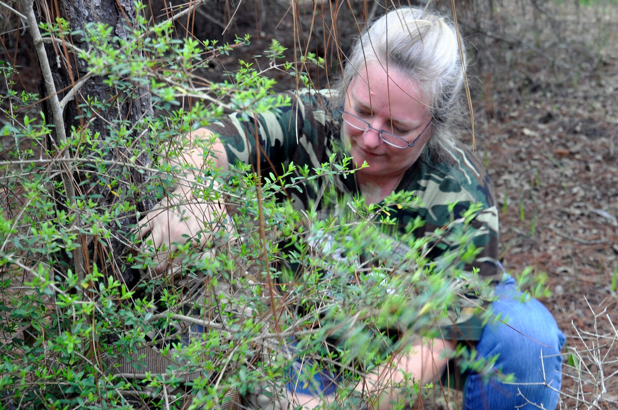 Sabrina Honda, Hurlburt Field Library, prepares one of three Ranger Rick locations for use in one of the base’s wooded areas on Hurlburt Field, Fla., April 15, 2011.  The Library encourages families to spend time together having fun outdoors, and the Ranger Rick program is one method they are using. (U.S. Air Force photo/Tech. Sgt. Stacy Fowler)