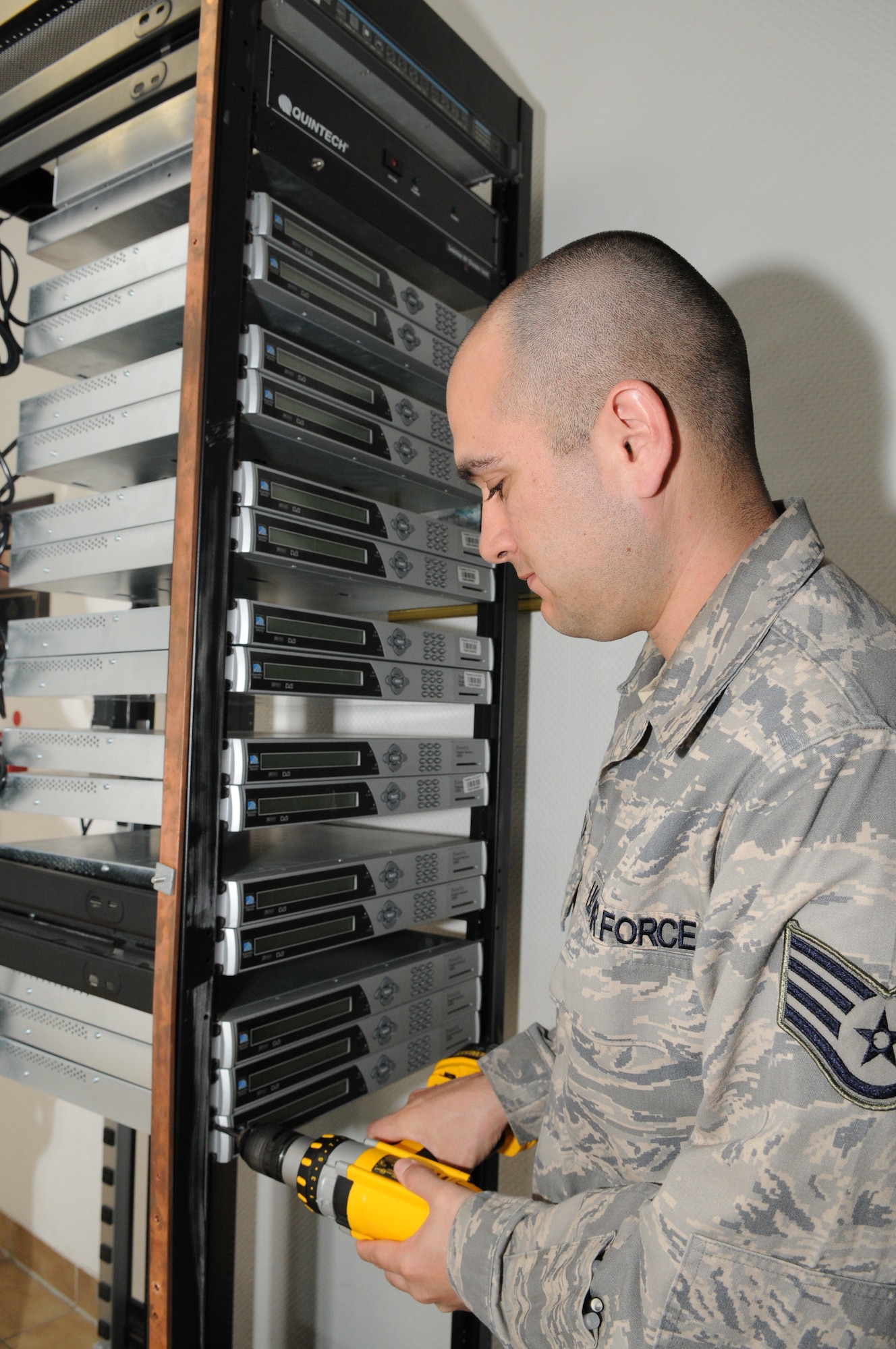 SPANGDAHLEM AIR BASE, Germany – Staff Sgt. Modesto Alcala, Armed Forces Network Spangdahlem broadcast maintenance supervisor, installs new satellite decoders on a decoder rack April 20 at Bitburg Annex. The new decoders were given to AFN by the Defense Media Activity and will soon replace older equipment when AFN Spangdahlem moves into its new renovated building on Spangdahlem. (U.S. Air Force photo/Senior Airman Nick Wilson)