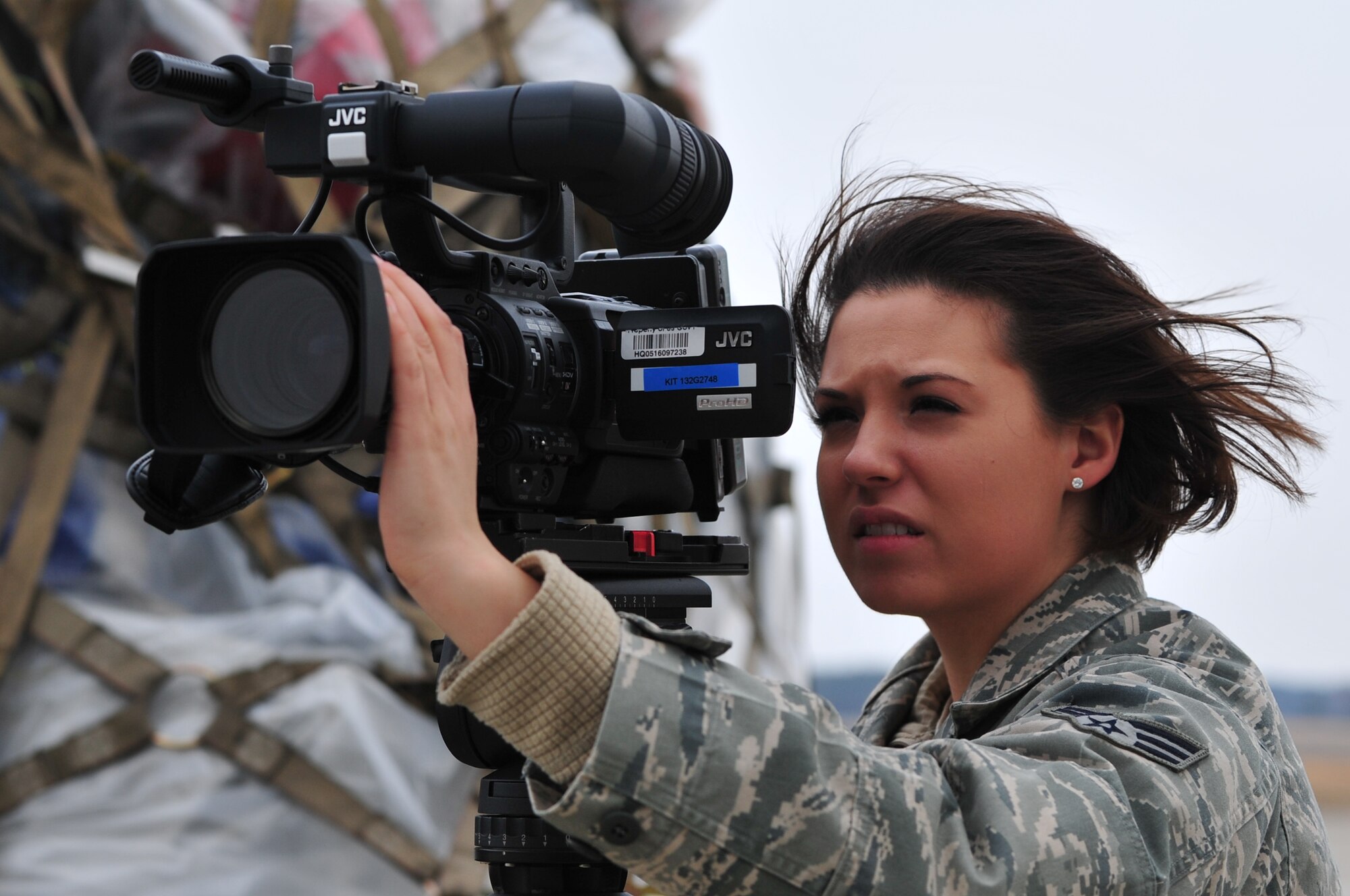 U.S. Air Force Senior Airman Barbara Patton, a Television and Radio Broadcaster with the Armed Forces Network, Detachment 12 from Misawa AB, and a Stafford, Va.-native, videotapes the cargo movement of humanitarian assistance in support of Operation Tomodachi in Aomori Prefecture, Japan on April 4, 2011.
