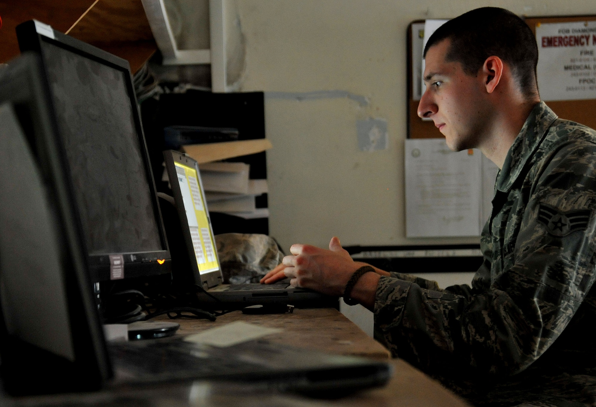 Senior Airman Joseph Kerner, the 151st Expeditionary Signals Battalion system administration shop NCO in charge, re-images a laptop, April 14, 2011 at Contingency Operating Site Diamondback. (U.S. Air Force photo by Senior Airman Andrew Lee/Released)