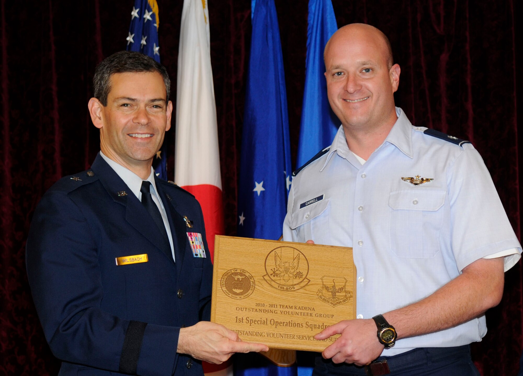 KADENA AIR BASE, Japan -- Lt. Col. Richard Carrell (right), the 1st Special Operations Squadron operations officer, poses for a photo with Brig. Gen. Kenneth Wilsbach, the 18th Wing commander, after being presented Team Kadena's 2010 Angel Award for the Volunteer Unit of the Year at the Kadena Annual Volunteer Recognition Ceremony here April 18.  The 1st supported the Misato Children's Home and multiple orphanages throughout the local community and across the Pacific Theater in 2010 supporting more than 500 children -- nearly 10 times the size of the unit of roughly 50 people. (U.S. Air Force photo by Airman 1st Class Brooke Beers)
