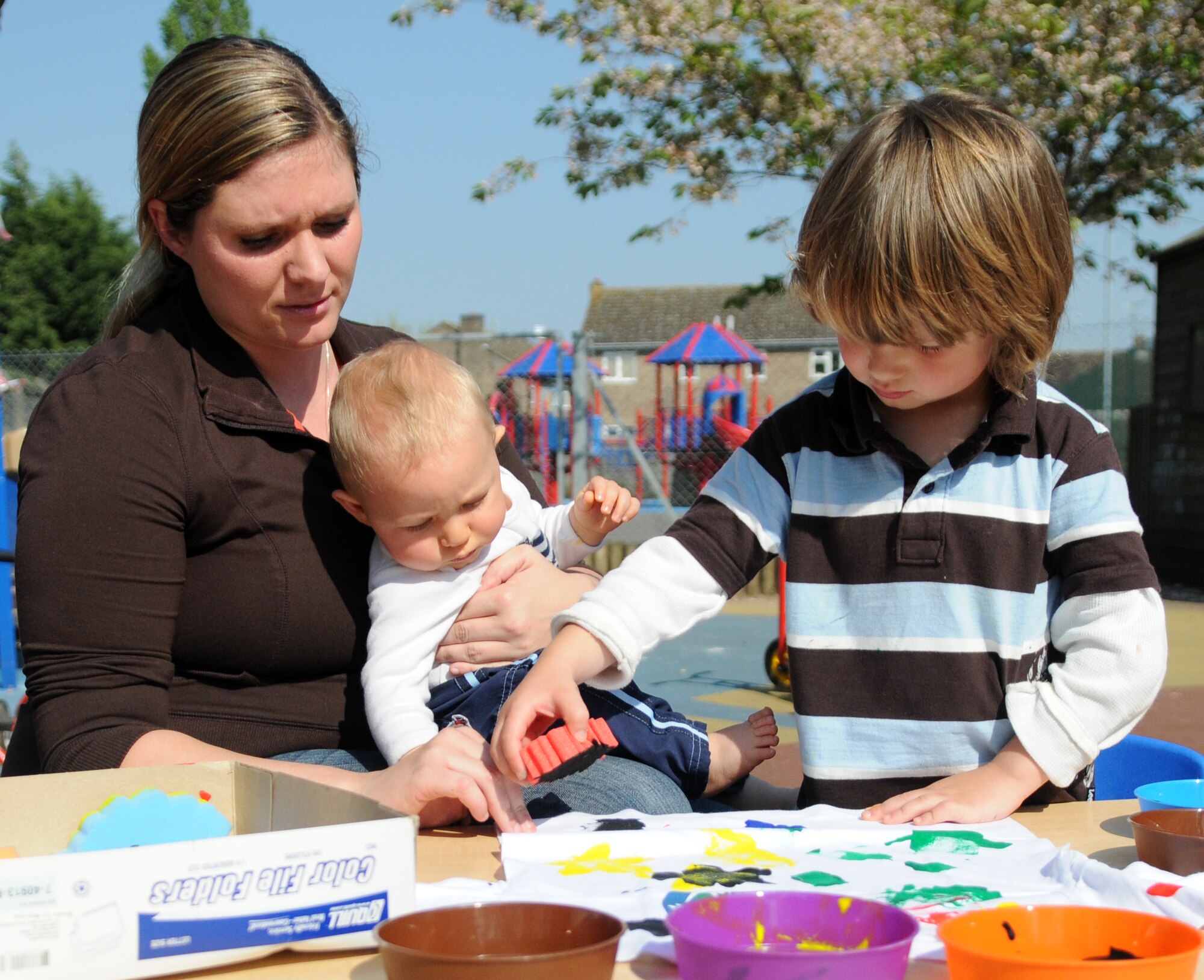 RAF MILDENHALL, England – Katie, Gavin, and Jacob, family of Tech. Sgt. Justin Gentile, 352nd Special Operations Group, make a t-shirt during an Earth Week event at the RAF Mildenhall Child Development Center April 19, 2011. Children from the CDC made t-shirts and planted plants in honor of Earth Week. The first Earth Week was celebrated 14 years ago. (U.S. Air Force photo/Airman 1st Class Rachel Waller)