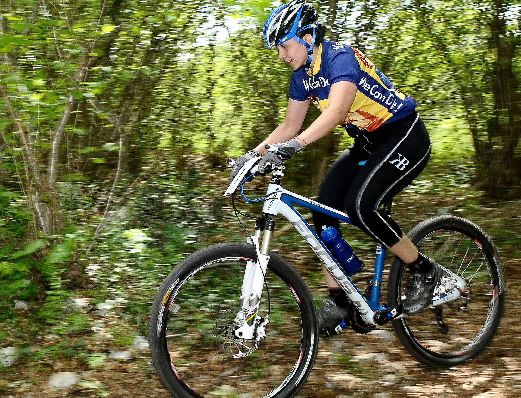 Angelica Rodriguez from Illeshiem Army Air Field, Germany, rides her bicycle through a wooded trail in Aviano, Italy, during the U.S. Forces Europe Mountain Bike Series April 16. The mountain bike competition was part of the Aviano Super Cycling Weekend, hosted by the 31st Force Support Squadron and welcomed American cyclists from bases throughout Europe. (U.S. Air Force photo by Airman 1st Class Katherine Windish)