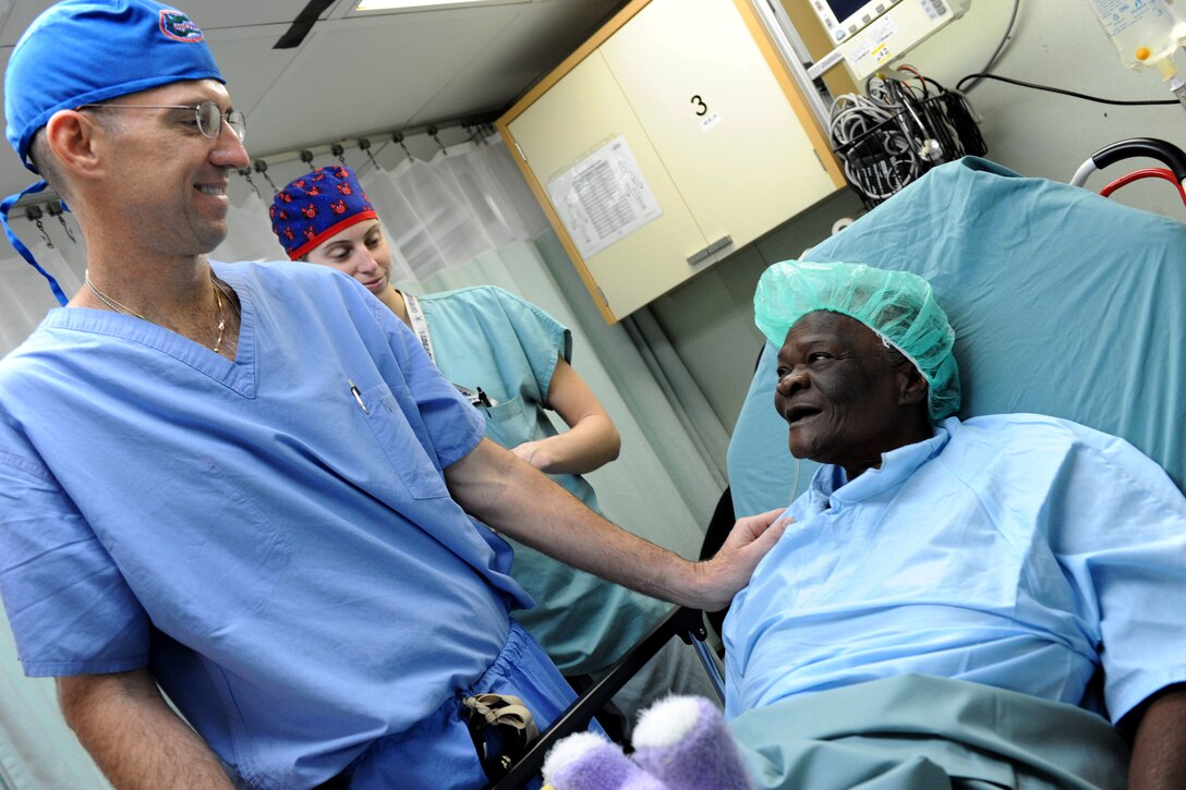 U.S. Navy Cmdr. Eric Gessler, left, an ear, nose and throat doctor