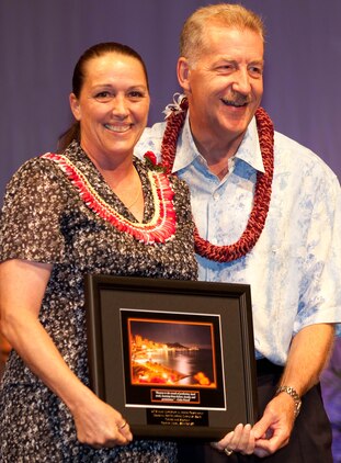 Colette Fisher (left), a budget technician with U.S. Marine Corps Forces, Pacific’s Plans and Polices section, accepts the Federal Employee of the Year Award in the clerical and assistant category from the Honorable Peter Carlisle, mayor of the city and county of Honolulu, during the 55th Annual Excellence in Federal Government Awards Luncheon and Expo April 21 at the Sheraton Waikiki Hotel, here. The event was held to recognize federal employees for their contributions and excellence within their agency.