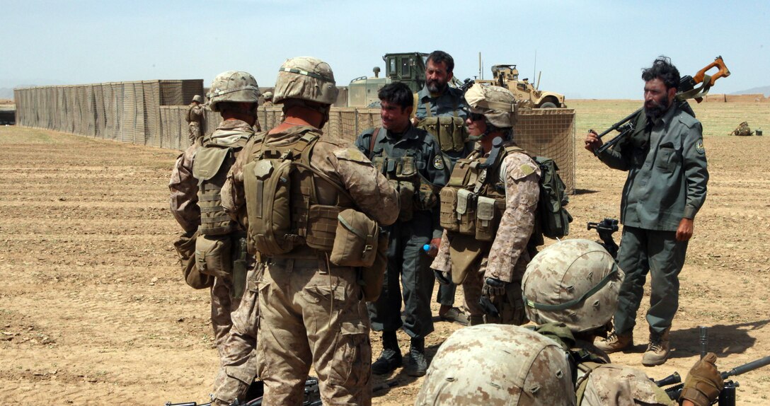 Marines with Company L, 3rd Battalion, 2nd Marines, interact with the Afghan Uniformed Police during a joint operation to build a Patrol Base Rogers, April 21.  The Base will expand the Now Zad security bubble and will reduce the insurgent presence in the area.