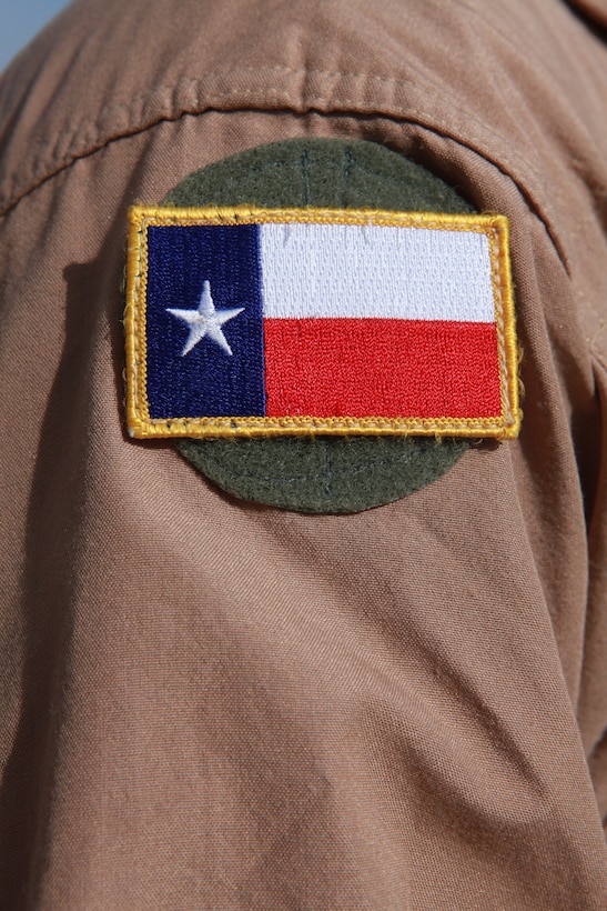 Capt. Wesley R. Ogden, a fixed wing planner with 2nd Marine Aircraft Wing (Forward), wears a Texas patch on his flight suit during a remembrance ceremony for San Jacinto Day at the 2nd MAW (Fwd.) headquarters compound on Camp Leatherneck, Afghanistan, April 21. San Jacinto Day commemorates a battle between the Texas Army and Mexican forces and is considered the turning point for Texas' independence from Mexico, April 21, 1836. “I decided to offer an opportunity for us to gather in remembrance, here, for motivation and morale,” said Ogden, a native of Houston. “It's beneficial to honor the traditions, values, and customs of the state and country that we joined to defend.  It reminds us why we're Marines.”