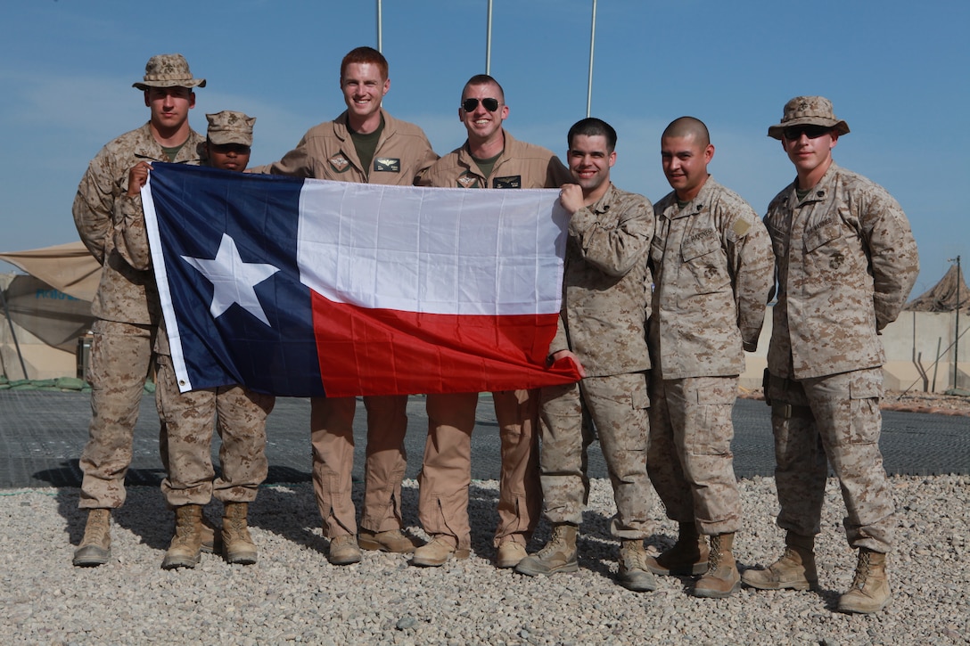 Marines with 2nd Marine Aircraft Wing (Forward) hold up the Texas state flag during a remembrance ceremony for San Jacinto Day at the 2nd MAW (Fwd.) headquarters compound on Camp Leatherneck, Afghanistan, April 21. San Jacinto Day commemorates a battle between the Texas Army and Mexican forces and is considered the turning point for Texas' independence from Mexico, April 21, 1836.