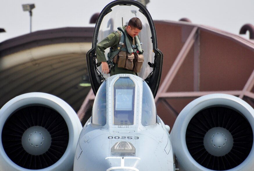 Capt. Dan Haugh, 25th Fighter Squadron, climbs out of the cockpit of an A-10 Thunderbolt II April 21.The last two A-10C Thunderbolt II aircraft return to the Korean Peninsula from Exercise COPE TIGER/Balikatan deployment, which marks the first time that all A-10C model aircraft assigned to Osan AB ROK have been on the Korean Peninsula at the same time. The A-10C's primary mission is to provide lethal, precision firepower in any potential close air support scenario. (U.S. Air Force photo/Staff Sgt. Chad Thompson)