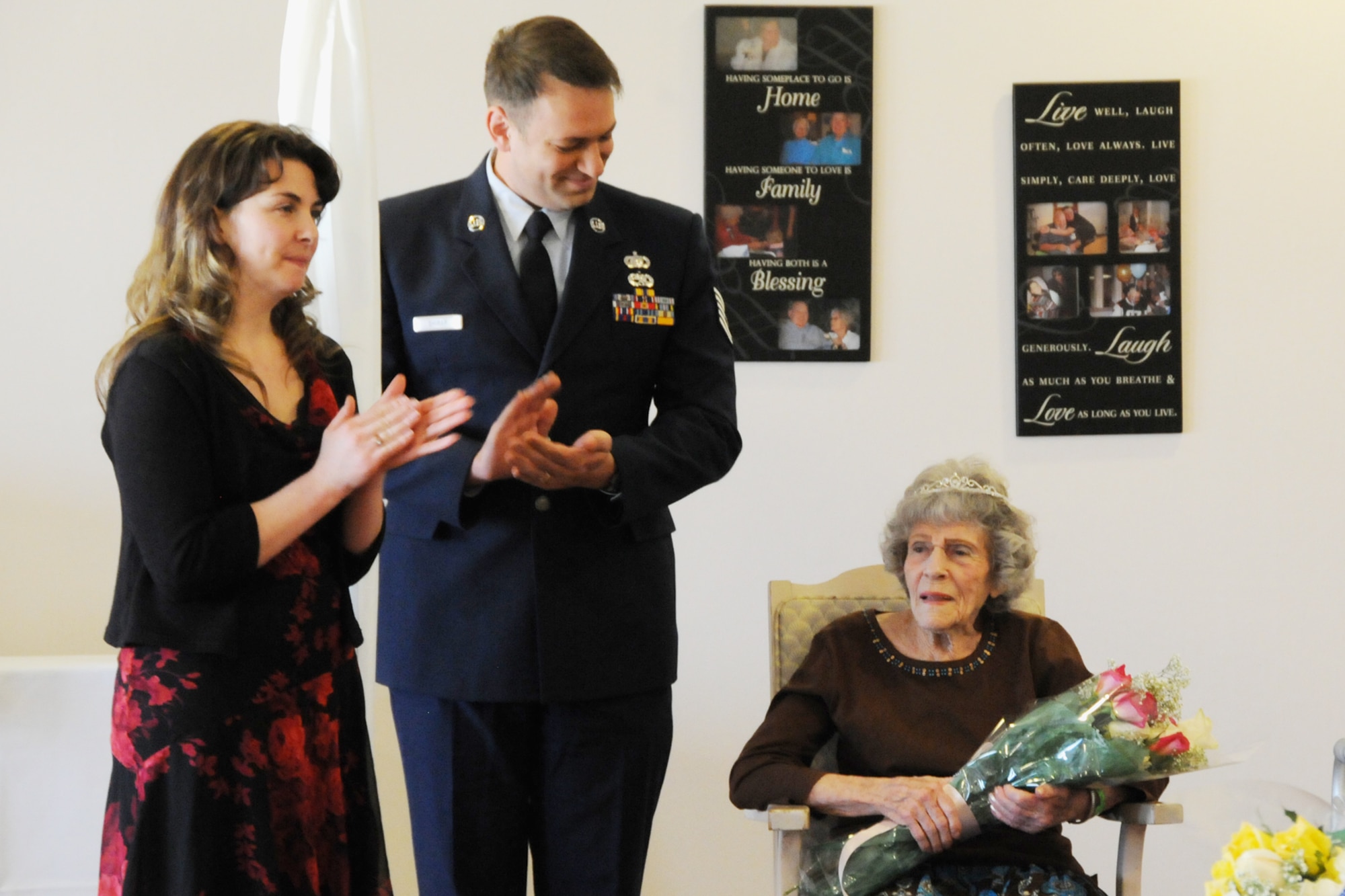 Tech. Sgt. Michael Shirar, 173rd Fighter Wing Maintenace Training Manager, and Tammy Smeed, Plum Ridge Marquis Care Activitites Director, clap for Mrs. Irene Dalton, the 2011 Rose Queen Princess, during the ceremony.  Members of the Oregon Air National Guard volunteered to help with the 2011 Rose Queen Corenation ceremony at Plum Ridge Marquis Care in Klamath Falls, Ore. April 8, 2011. (U.S. Air Force Photo by Tech.Sgt. Jennifer Shirar, RELEASED)
