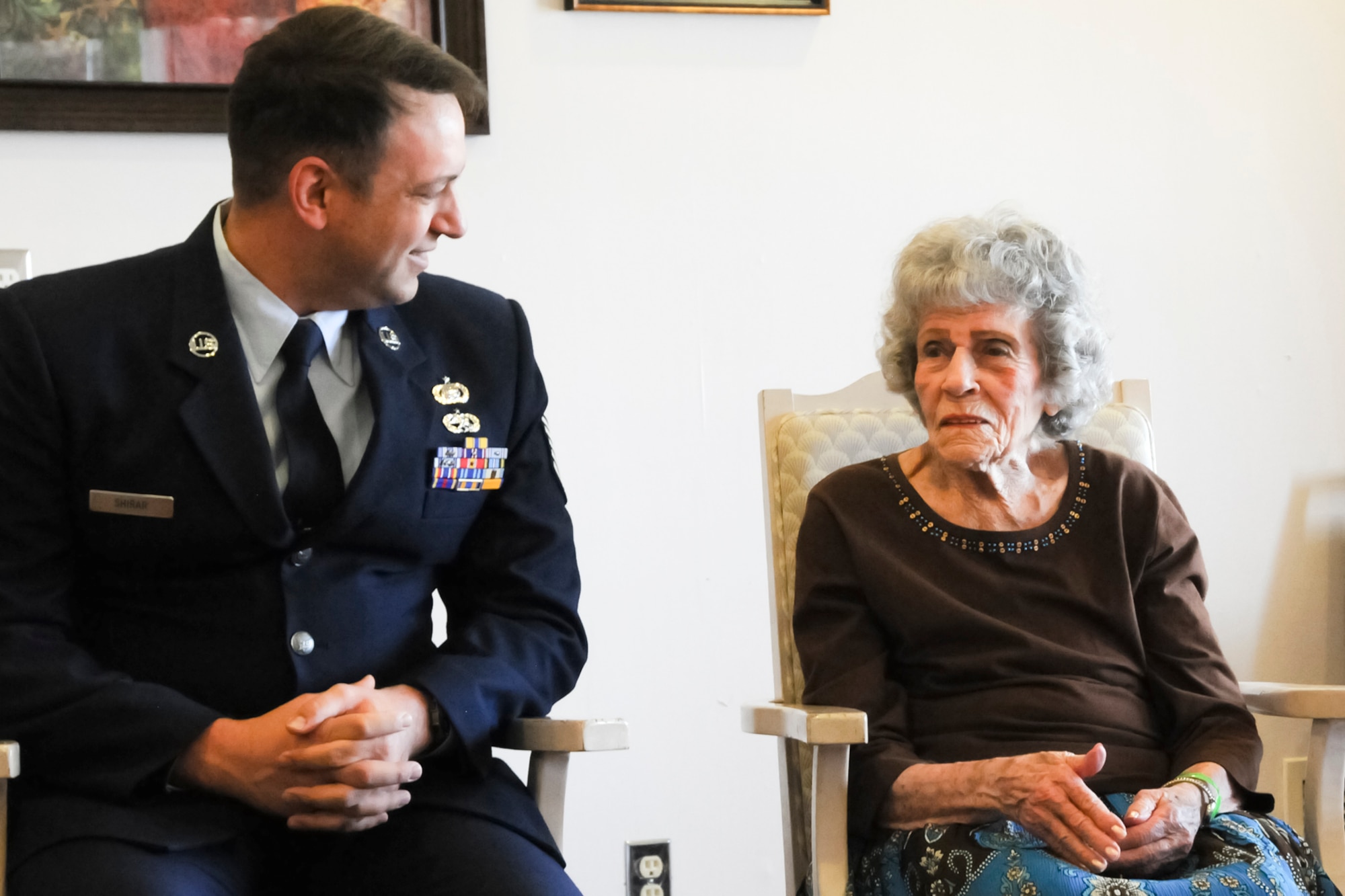 Tech. Sgt. Michael Shirar, 173rd Fighter Wing Maintenace Training Manager, talks with Mrs. Irene Dalton, one of the Rose Queen canidates, before the ceremony.  Members of the Oregon Air National Guard volunteered to help with the 2011 Rose Queen Corenation ceremony at Plum Ridge Marquis Care in Klamath Falls, Ore. April 8, 2011. (U.S. Air Force Photo by Tech.Sgt. Jennifer Shirar, RELEASED)