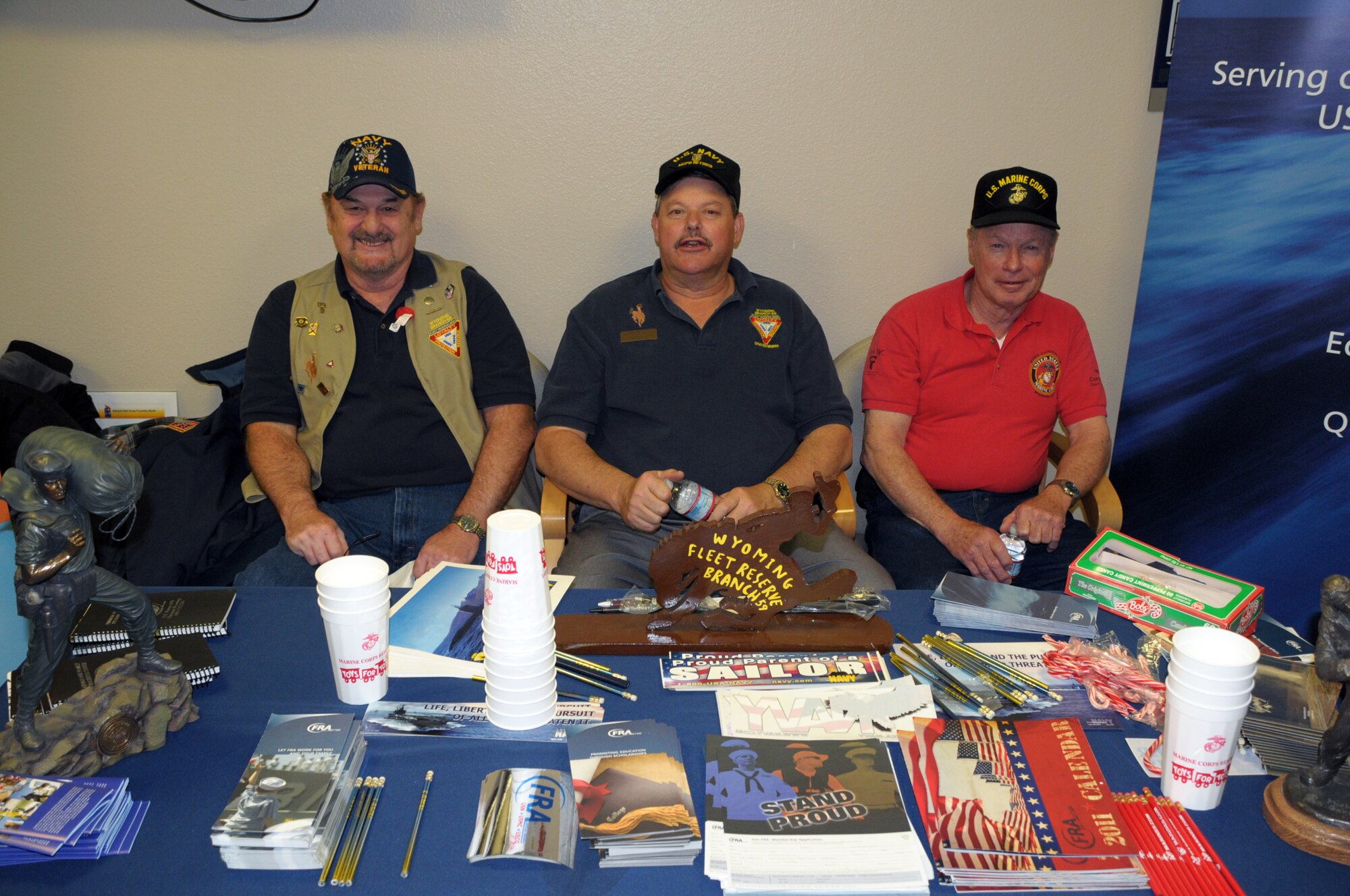 Master Chief Petty Officer (ret) Mike Archer, Retiree Activities Officer, oversees an  table with retiree information and military memorabilia with fellow military retirees from the Cheyenne area at the 90th Medical Group during Warren's Military Retiree Appreciation Day Saturday. (U.S. Air Force photo by Blaze Lipowski)