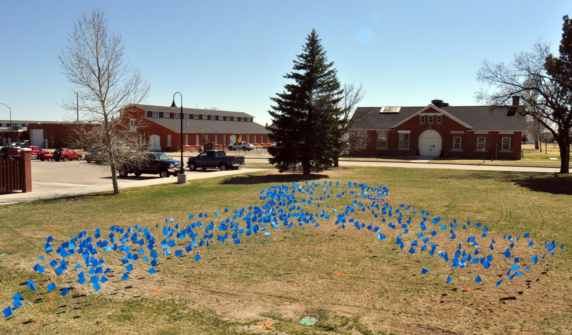 Last fiscal year, the Air Force received 585 reports of sexual assaults. Representing each reported case, 585 blue landscape marking flags were placed in the pattern of the Sexual Assault Prevention ribbon for Sexual Assault Awareness Month. These flags were placed behind bldg. 242 on Old Glory Road. Staff Sgt. Charles Coren, Senior Airmen Justin Kash and Kyle Gant, Airman 1st Class Holdin Pennington, all of 90th Missile Security Forces Squadron; Master Sgt. Maria Nave and James Hunt, both from 90th Missile Wing Equal Opportunity Office; and Kathy McCoole and Marty Peek, Sexual Assault Prevention and Response office, placed the flags. (U.S. Air Force photo by Senior Airman Daryl Knee)