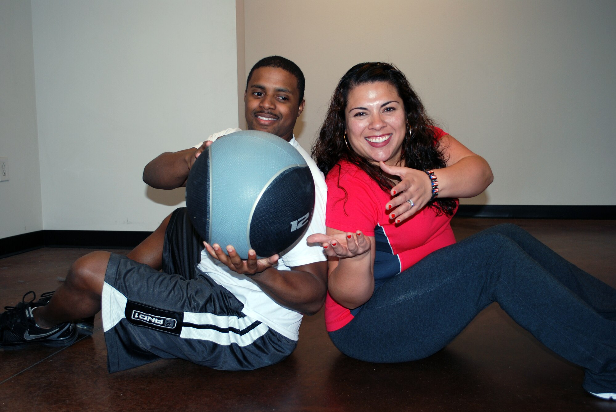 Kendrick Calix, 90th Logistic Readiness Squadron, and Ana Gonzalez, wife of Staff Sgt. Edgar Gonzalez, 90th Security Forces Group, pass a medicine ball during a workout. Both are current competitors in the 14-week Warren Fitness Challenge that will end April 29. More than 100 participants started the challenge January 21. The challenge includes greatest weight loss and total participation points. Teams and individual winners will be announced at the Awards Ceremony on Fitness Day, May 11 at 3 p.m. in the Freedom Hall Fitness Center Gymnasium. Everyone is invited to attend and cheer on the competitors. (Courtesy photo)