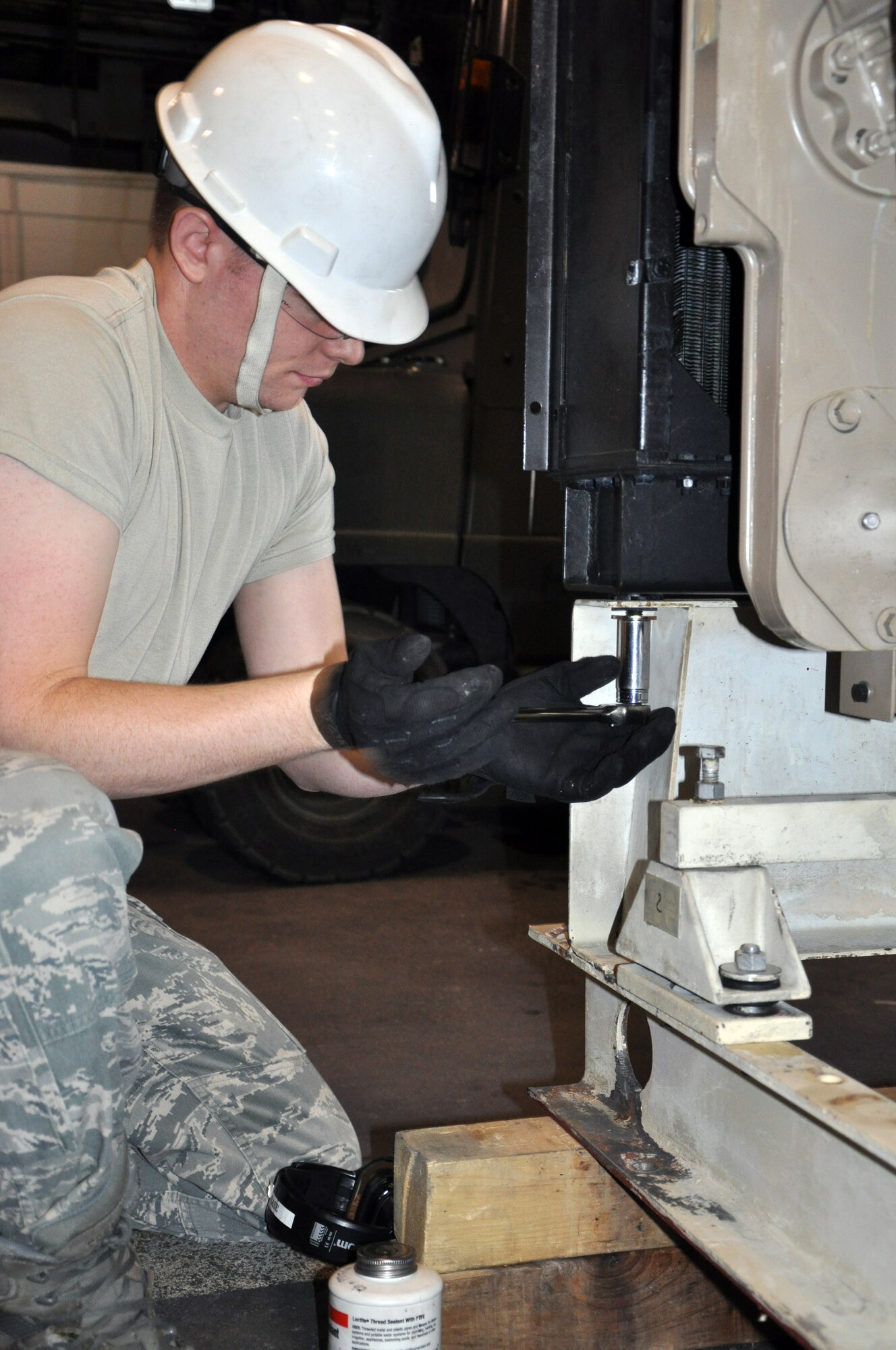 Senior Airman Ryan Pease, 90th Civil Engineer Squadron, tightens a mounting bolt on a Cummins diesel engine unit here Wednesday. The generator is part of the repowering of the 90th and 91st Missile Wing’s missile fields. (U.S. Air Force photo by Staff Sgt. Mike Tryon)