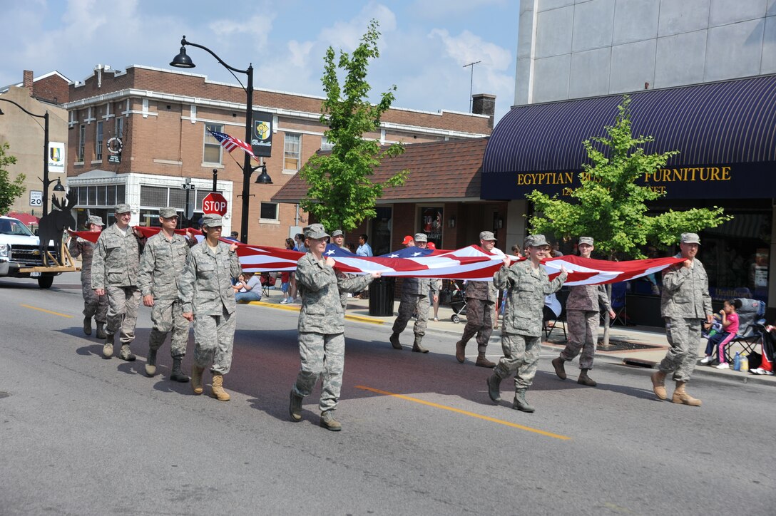 Airmen of the 932nd Airlift Wing march the U.S. flag in the 2010 Belleville, Ill, annual Memorial Day Parade.  Volunteers for this year's parade can sign-up at the wing public affairs office during the May UTA in bldg. 3650.  (U.S. Air Force photo/932nd AW Public Affairs) 