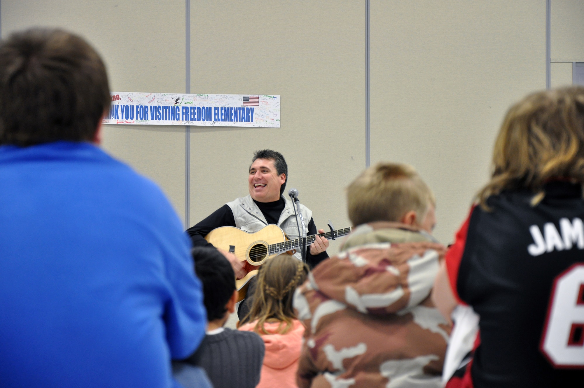 Randy Beard, founder of “Learning Through Lyrical Literacy,” sings “Onomatopoeia” to the fifth and sixth graders of Freedom Elementary School on Friday. Mr. Beard spent the day teaching the children the six traits of writing and turned the children’s writings into music. (U.S. Air Force photo by Staff Sgt. Mike Tryon)