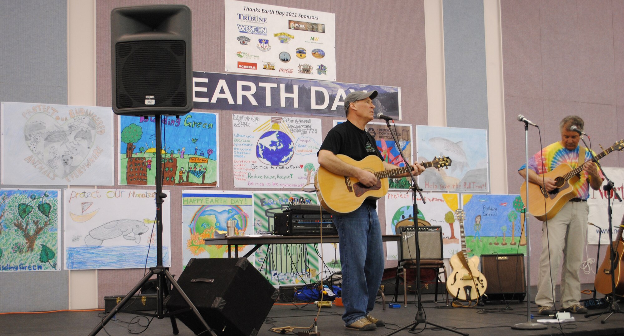 A band, sponsored by Montana Waste Systems, provides entertainment during the annual Earth Day celebration April 16.  Their stage was decorated with posters by the winners of the Earth Day poster contest.  (U.S. Air Force photo/Airman Cortney Hansen)