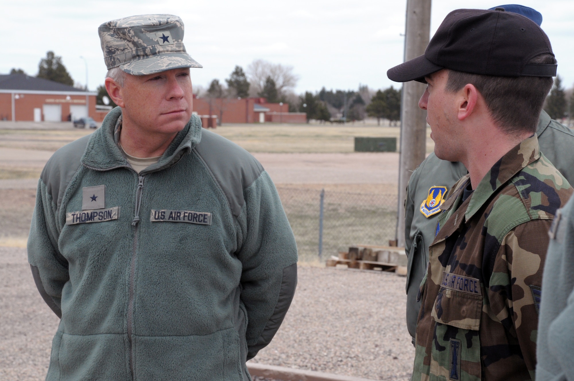 Staff Sgt. Geoffrey Kirchner, 90th Missile Maintenance Squadron, briefs Brig. Gen. John F. Thompson, Air Force Program Executive Officer for Strategic Systems, outside Warren’s launch facility trainer, Uniform-01, on the mission of the 90th MMXS and the role that U-01 plays in preparing the maintenance Airmen to do their job, during the general’s visit April 13. (U.S. Air Force photo by Blaze Lipowski)