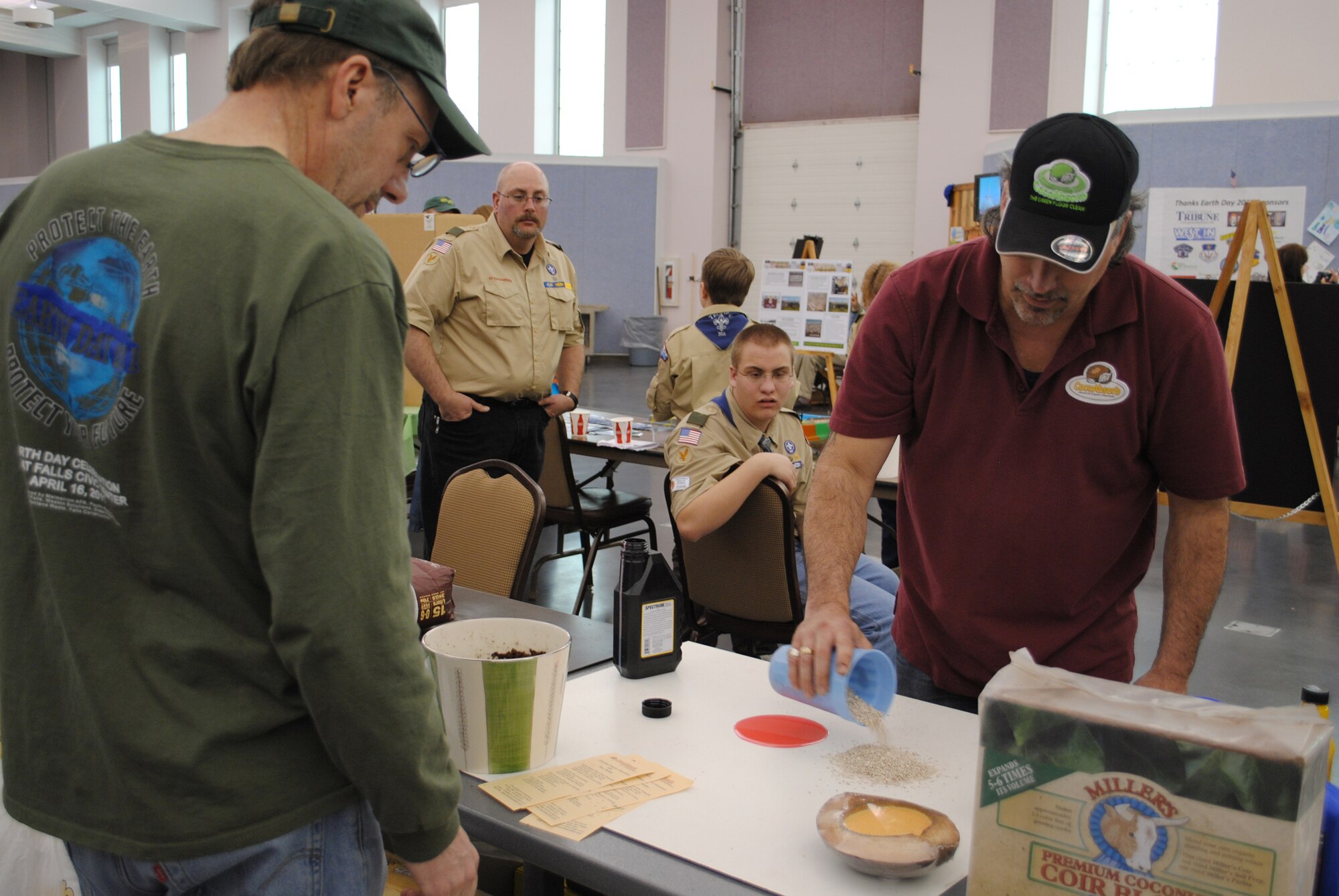 Rudy Verzuh, a 341st Civil Engineer Squadron environmental engineer, watches as Tory Ewing, the director of sales for CocoAbsorb, performs a demonstration.  Mr. Ewing's demonstration showed the difference between absorption with kitty litter and absorption with his product made from 100 percent coconut shell.  (U.S. Air Force photo/Airman Cortney Hansen)