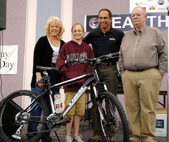 From left to right: Debbie Kimball, a representative of the City of Great Falls; Rachael Marjamaa, an East Middle School 7th grader; Mark Bell, principal client service manager at Weston Solutions; and Frank Carpenter, 341st Civil Engineer Squadron environmental protection specialist, stand for a photo with Rachael's new Trek bike she won at the Earth Day celebration April 16.  Rachael's name was drawn from a jar full of all of the names of the participants in the poster contest. (U.S. Air Force photo/Airman Cortney Hansen)