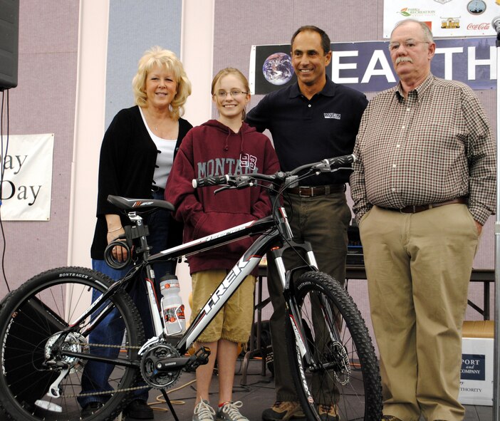 From left to right: Debbie Kimball, a representative of the City of Great Falls; Rachael Marjamaa, an East Middle School 7th grader; Mark Bell, principal client service manager at Weston Solutions; and Frank Carpenter, 341st Civil Engineer Squadron environmental protection specialist, stand for a photo with Rachael's new Trek bike she won at the Earth Day celebration April 16.  Rachael's name was drawn from a jar full of all of the names of the participants in the poster contest. (U.S. Air Force photo/Airman Cortney Hansen)