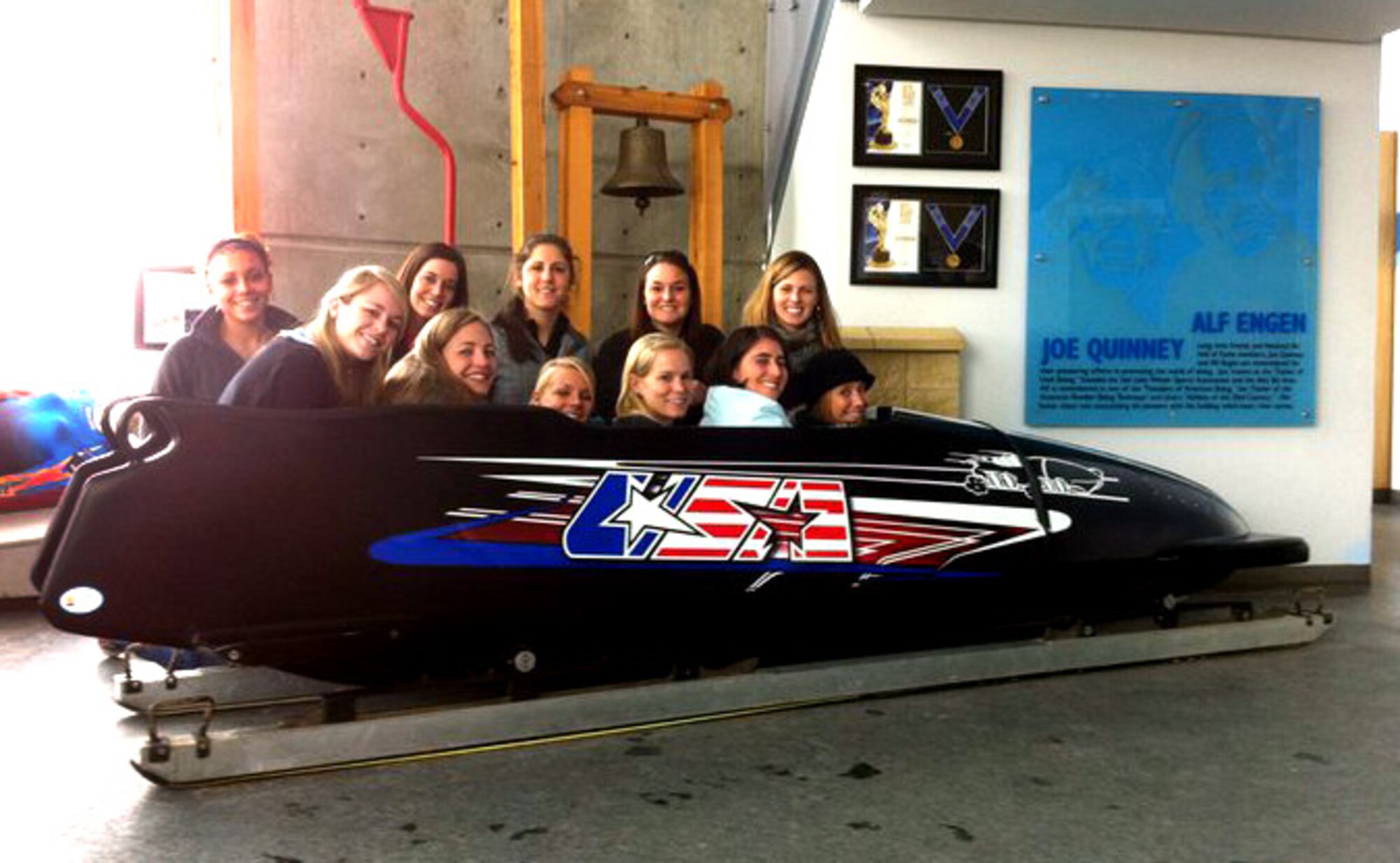 PARK CITY, Utah – (Fifth from left in front row) 1st Lt. Virginia Aguilar, 97th Medical Support Squadron medical readiness and medical information systems flight commander, poses with her teammates from the 2011 All Air Force Women’s Volleyball Team in an Olympic bobsled at Olympic Park. Lieutenant Aguilar, who was picked up for her versatility on the court, incurred a knee injury during her first game at the All Armed Forces Championship and is now recovering in hopes to play again next year. The team ranked third overall and sent three people to compete in Brazil for the Military World Games this summer. (Courtesy photo)
