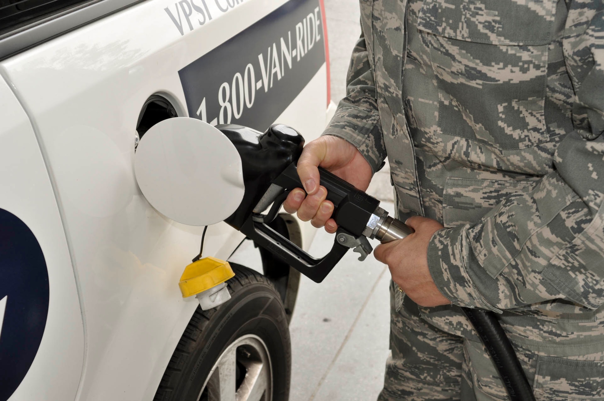 An Airman pumps gas into a rideshare van at a gas station across the street from March Air Reserve Base, Calif., April 18, 2011.  Defense Department service members and civilian employees who use an alternate form of transportation are eligible for monthly vouchers, which, in almost all cases, cover the cost of vanpooling, including gas.  (U.S. Air Force photo/ Megan Just)