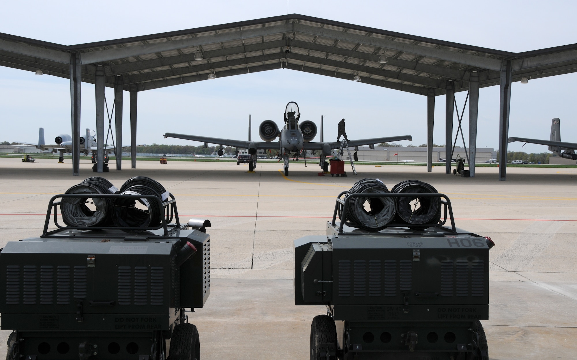 A 175th maintenance personnel inspects the wing of an A-10C Thunderbolt II attack jet under the new sunshades installed at the Maryland Air National Guard, 175th Wing at Warfield Air National Guard Base in Baltimore, Md., April 21, 2011.  The sunshades are design to help keep maintenance costs down. The shades will also protect the aircraft from rain, hail, snow and UV rays that can deteriorate gaskets, rubber seals, paint and other items costing more to maintain aircraft. 
(U.S. Air Force photo by Master Sgt. Ed Bard/Released) 
