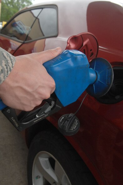Staff Sgt. Marcus O'Sullivan, 2nd Operations Group NCO in-charge of intelligence operations support, fuels up his vehicle at the Barksdale Shoppette. The Army Air Force Exchange Service surveys five local locations and sets their gasoline prices to the lowest price surveyed for each grade. (U.S. Air Force photo/Senior Airman Allison M. Boehm)(RELEASED)