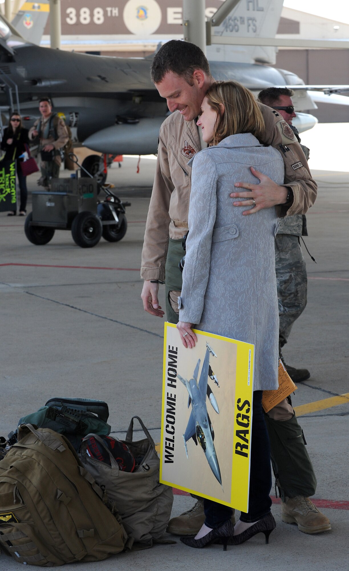 Capt. Mike Seltzer and his wife, Cat Seltzer, share a moment as the 4th Fighter Squadron returned to Hill Air Force Base on April 15.  (U.S. Air Force photo by Alex Lloyd)