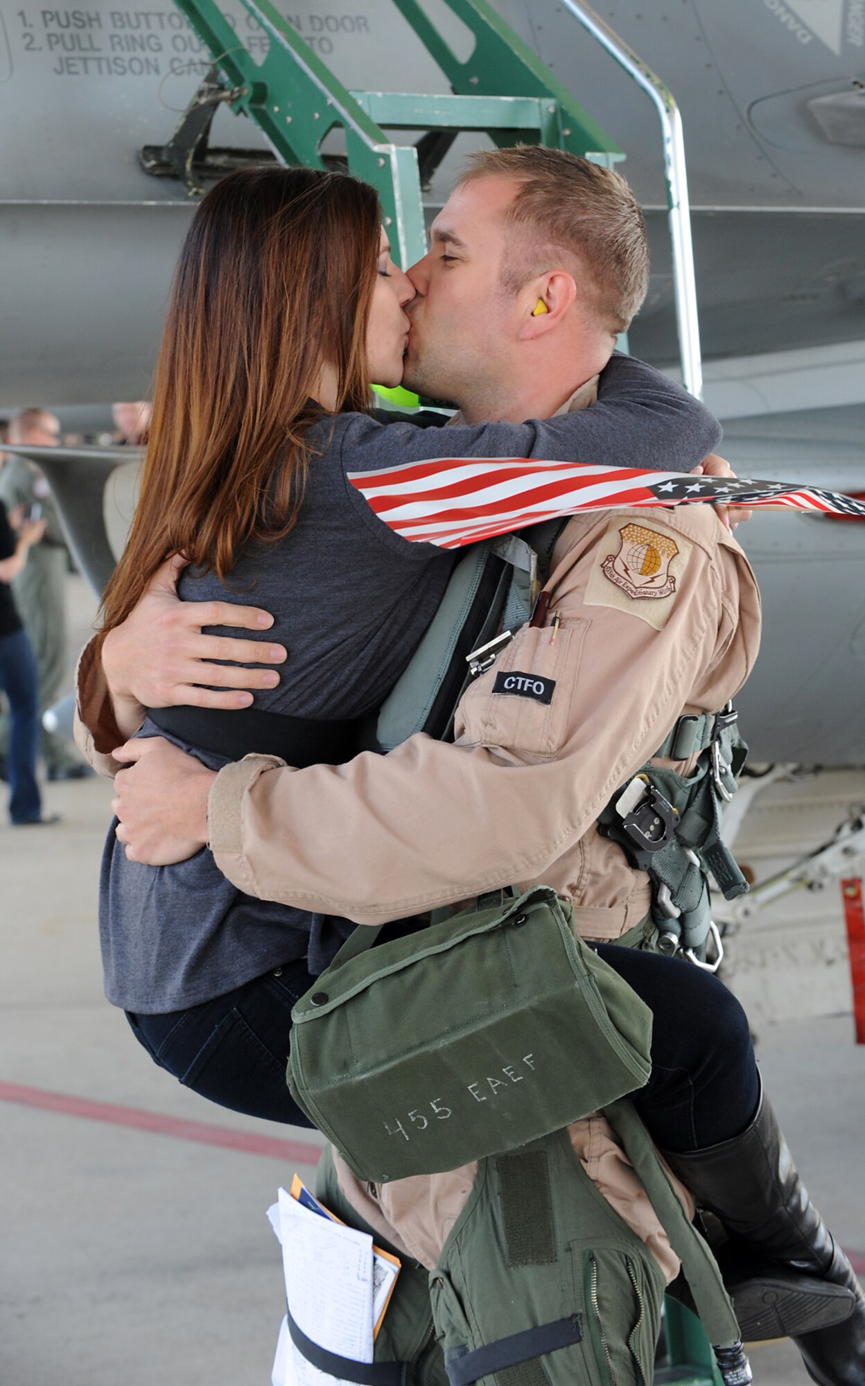 Kerri Bandy gets a long awaited hug and kiss from her husband, Capt. Aaron Bandy, of the 4th Fighter Squadron, as soon as he stepped off the ladder from his F-16 Fighting Falcon. (U.S. Air Force photo by Alex Lloyd)