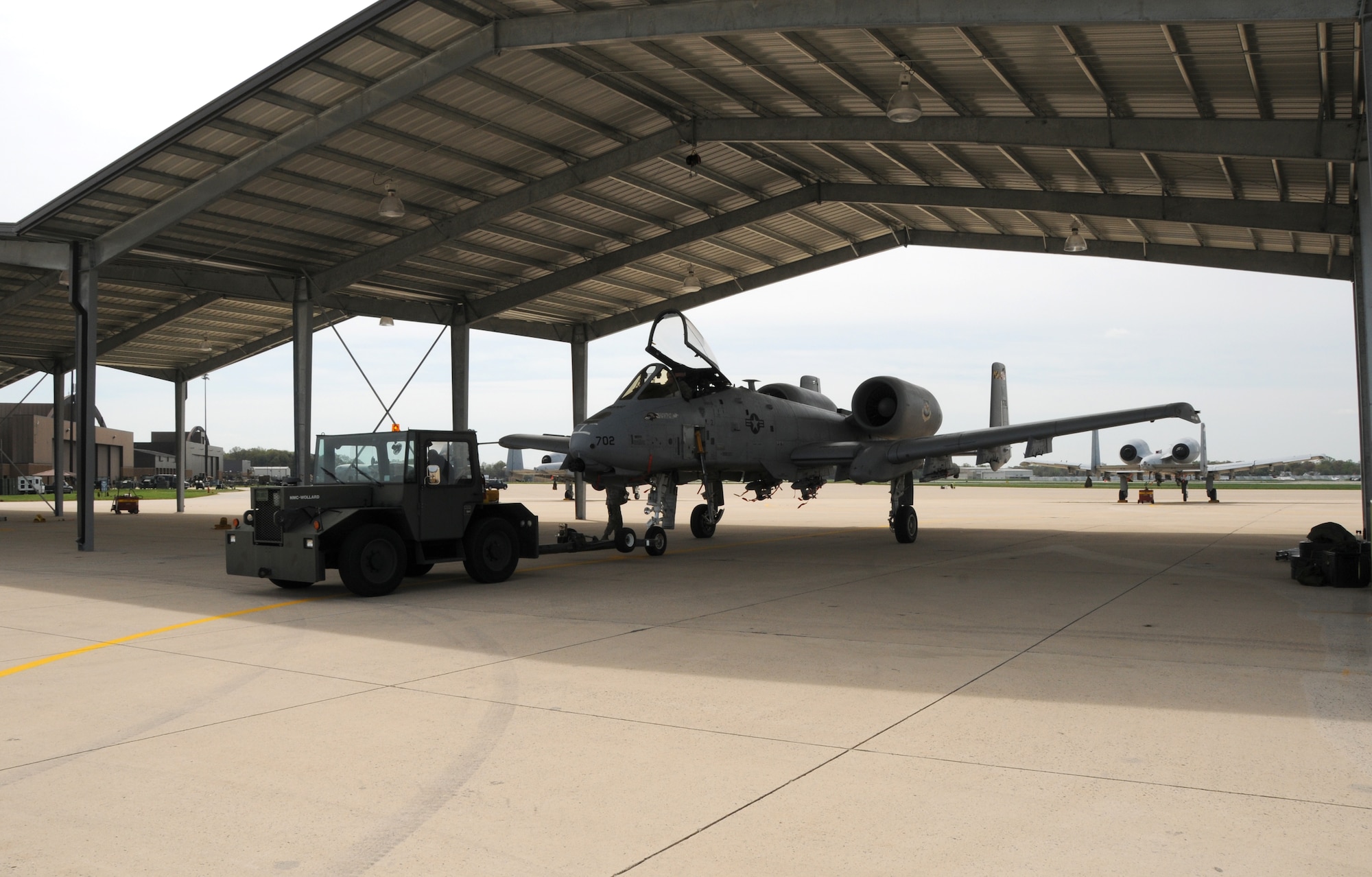 The first A-10C Thunderbolt II attack jet towed under the new sunshades installed at the Maryland Air National Guard, 175th Wing at Warfield Air National Guard Base in Baltimore, Md., April 21, 2011.  The sunshades are design to help keep maintenance costs down. The shades will also protect the aircraft from rain, hail, snow and UV rays that can deteriorate gaskets, rubber seals, paint and other items costing more to maintain aircraft. 
(U.S. Air Force photo by Master Sgt. Ed Bard/Released) 
