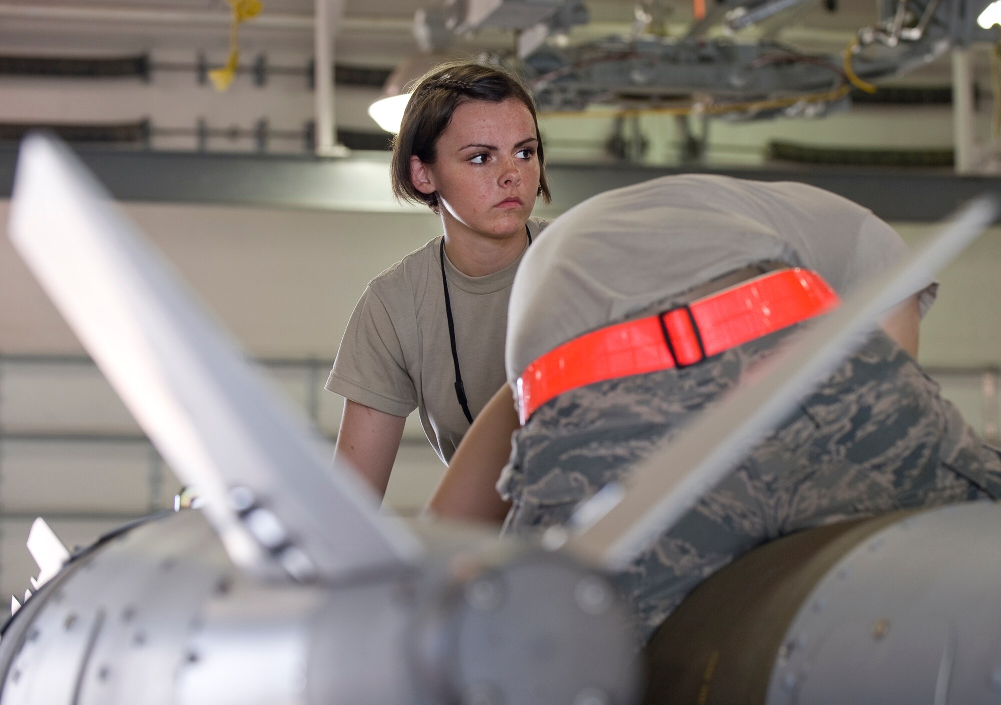 Airman 1st Class Katelynn Baker, 2nd Munitions Squadron, helps disassemble a Joint Direct Attack Munition GBU-31 in the munitions storage area on Barksdale Air Force Base, La., April 20. These 2,000 pound weapons are generated for the B-52H Stratofortress mission, and if not used are disassembled for storage. (U.S. Air Force photo/Senior Airman Chad Warren)(RELEASED)