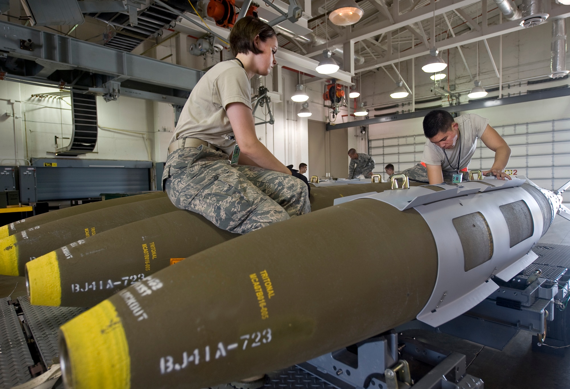 Airman 1st Class Katelynn Baker and Airman 1st Class Niko Bryson, 2nd Munitions Squadron, disassemble a Joint Direct Attack Munition GBU-31 in the munitions storage area on Barksdale Air Force Base, La., April 20. The JDAMs are built to support the B-52H Stratofortress mission, and if not used are disassembled for storage. (U.S. Air Force photo/Senior Airman Chad Warren)(RELEASED)