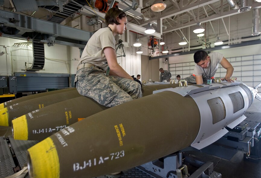 Airman 1st Class Katelynn Baker and Airman 1st Class Niko Bryson, 2nd Munitions Squadron, disassemble a Joint Direct Attack Munition GBU-31 in the munitions storage area on Barksdale Air Force Base, La., April 20. The JDAMs are built to support the B-52H Stratofortress mission, and if not used are disassembled for storage. (U.S. Air Force photo/Senior Airman Chad Warren)(RELEASED)