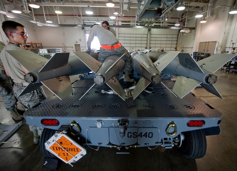 Airmen from the 2nd Munitions Squadron disassemble a Joint Direct Attack Munition GBU-31 in the munitions storage area on Barksdale Air Force Base, La., April 20. The B-52H Stratofortress is capable of carrying 12 of these 2,000-pound weapons externally. (U.S. Air Force photo/Senior Airman Chad Warren)(RELEASED)